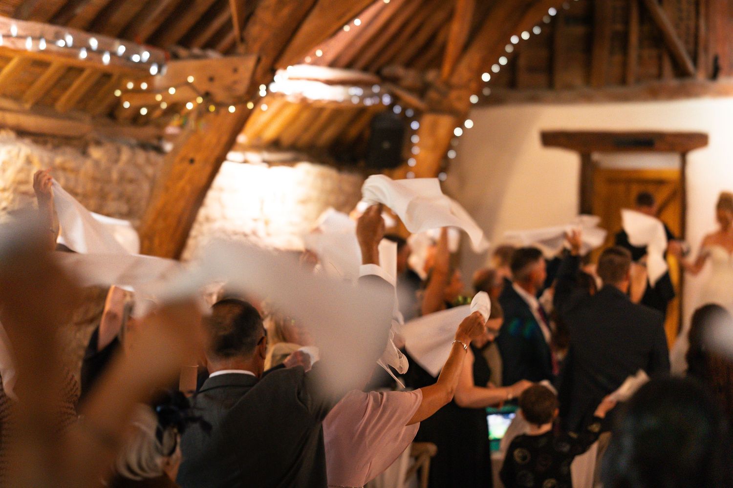 Napkins being waved as new bride and groom enter the wedding breakfast