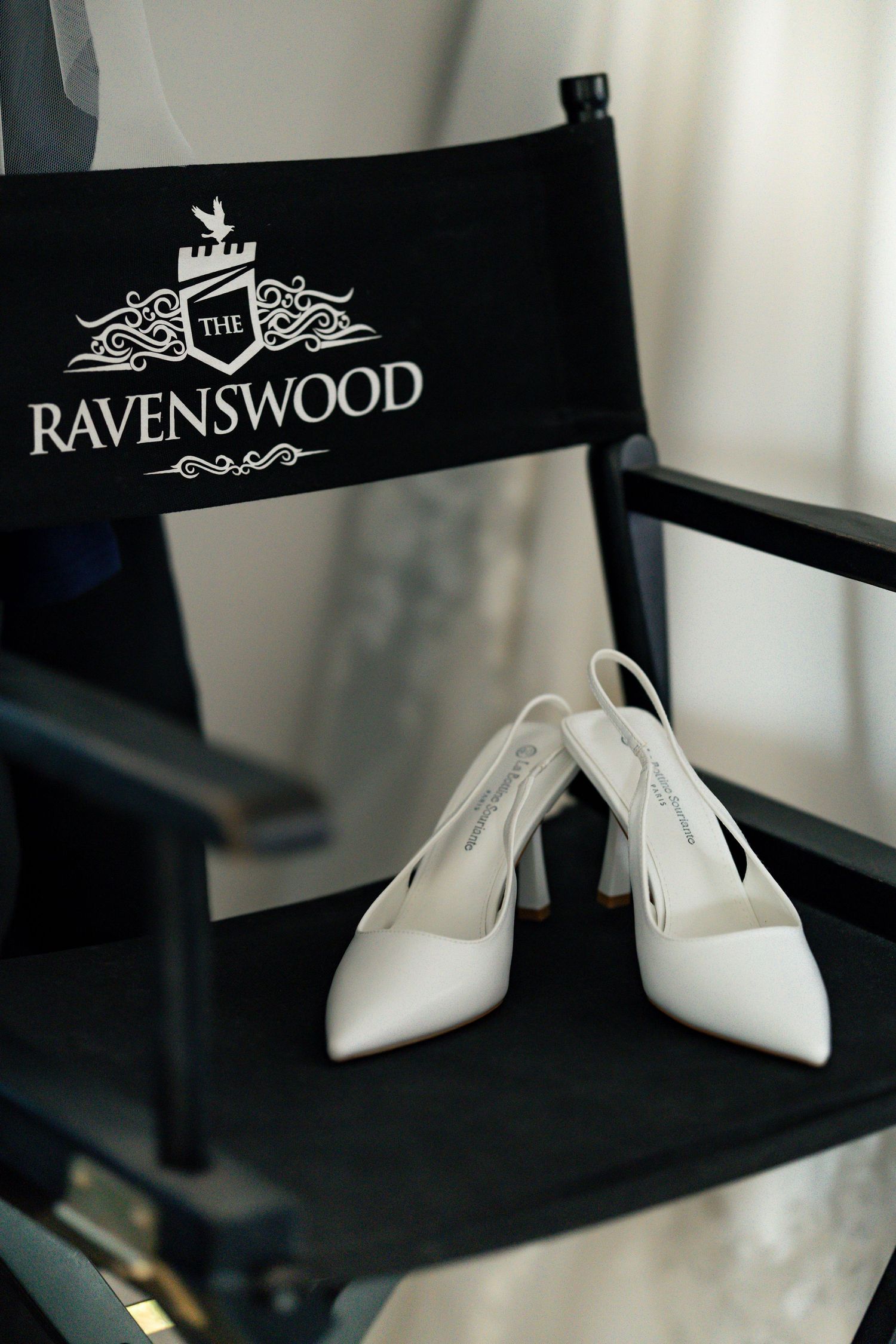 Wedding shoes on a director's chair at The Ravenswood Wedding Venue