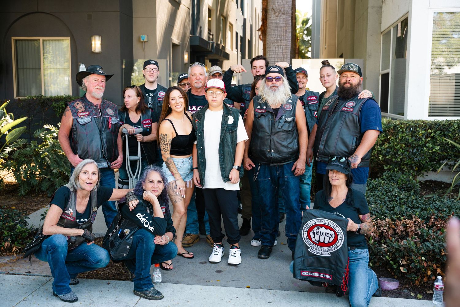 Group of people in casual attire posing together in a series of connected photos taken outdoors.