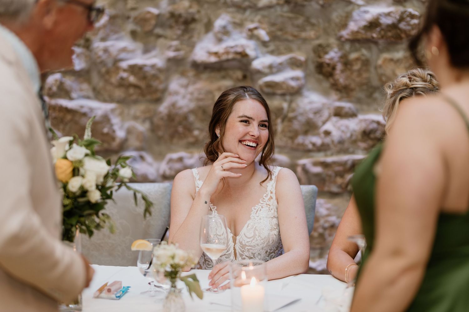 Candid moments of laughter and joy during wedding reception dinner.