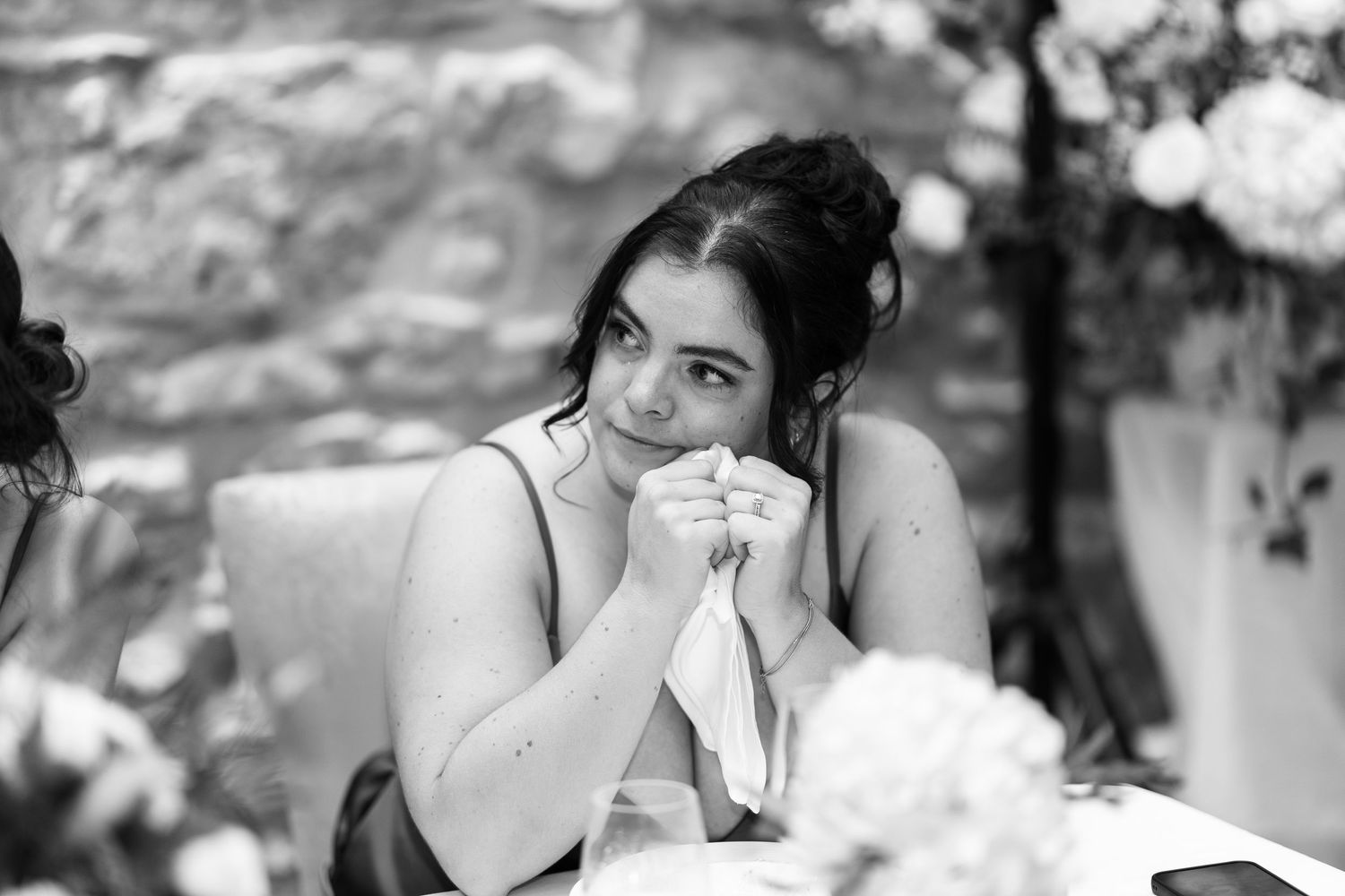 Black and white candid shots of wedding reception toasts and celebrations.