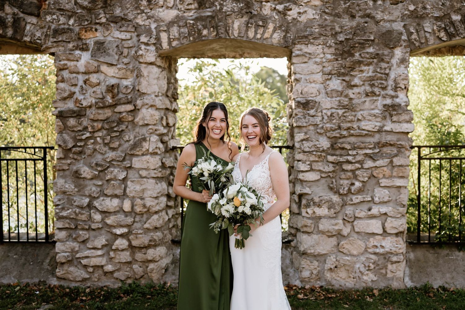 Wedding party photos taken against textured stone wall backdrop in natural lighting.