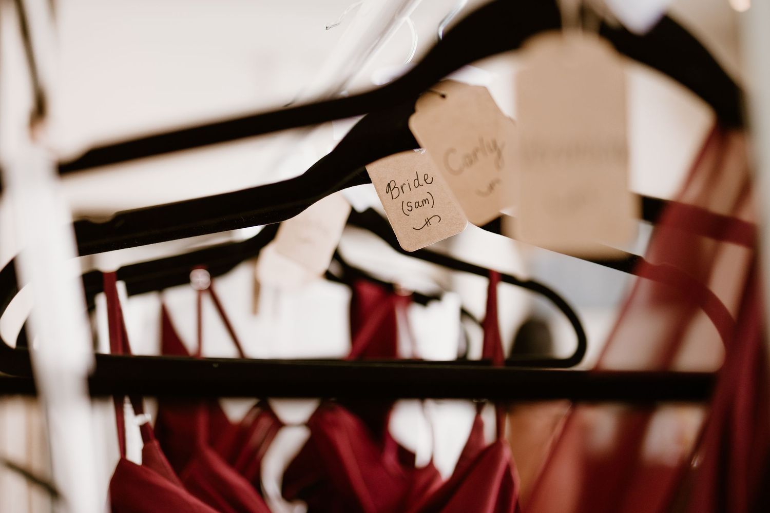 Wedding dress hangers with tags in soft focus.