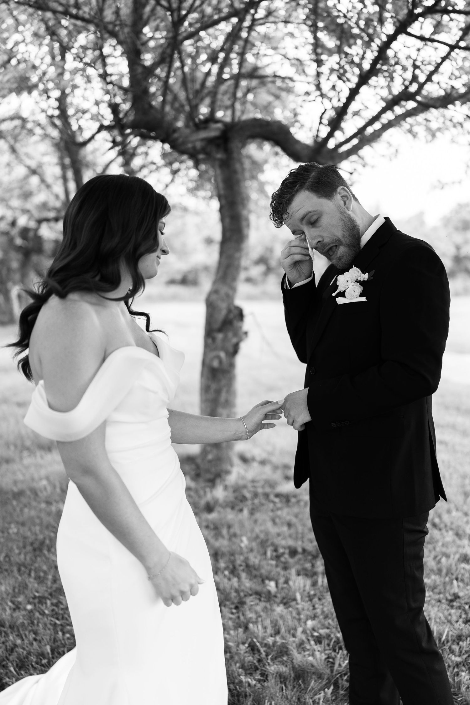Black and white wedding photos showing intimate moments between a bride and groom in a natural outdoor setting.