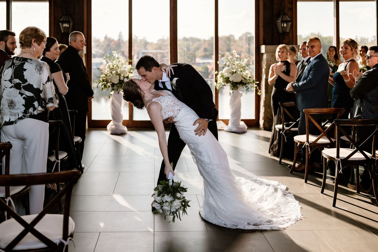 Wedding celebration moments captured in a sunlit venue with panoramic views.