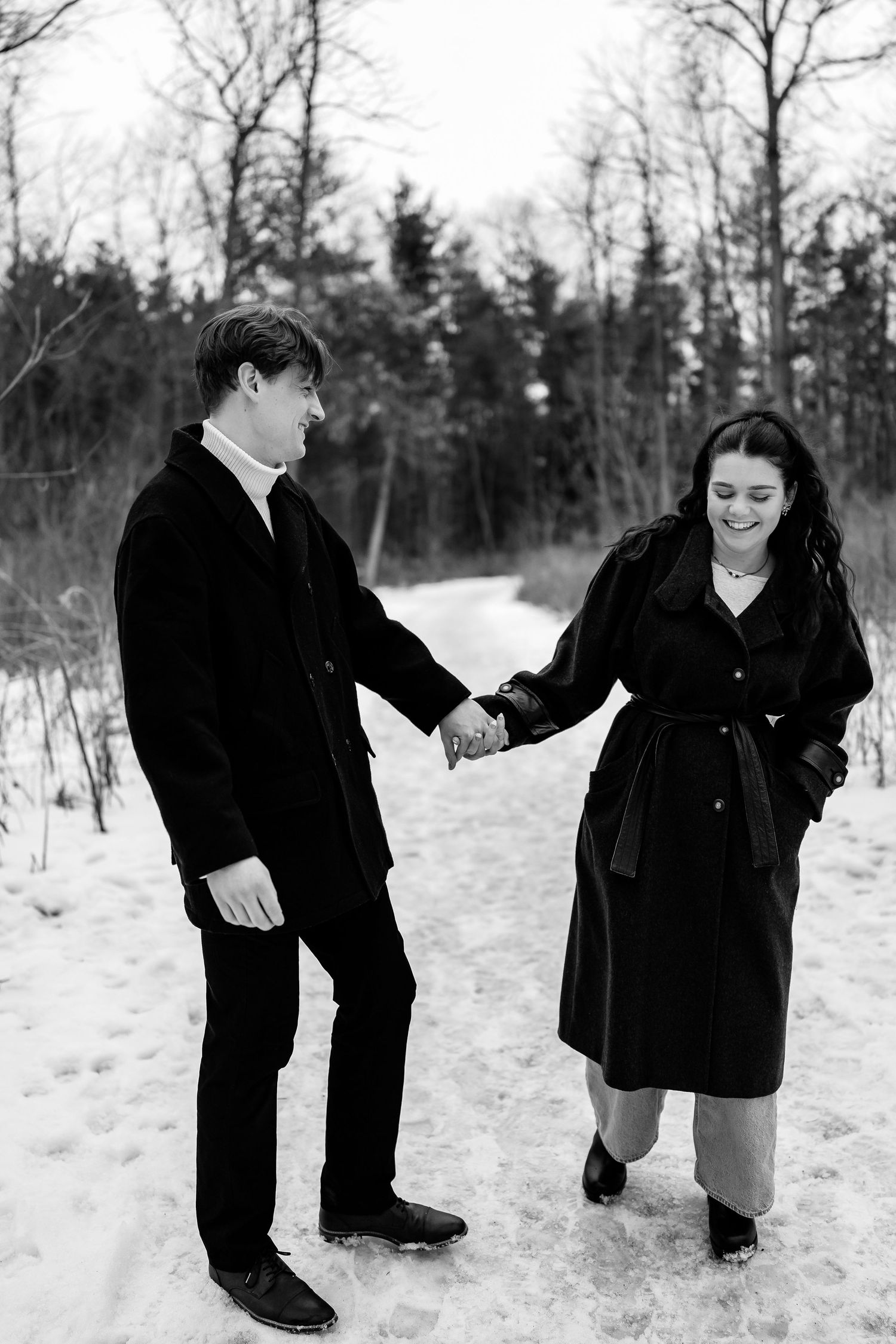 A playful winter photoshoot sequence showing a couple interacting in the snow.