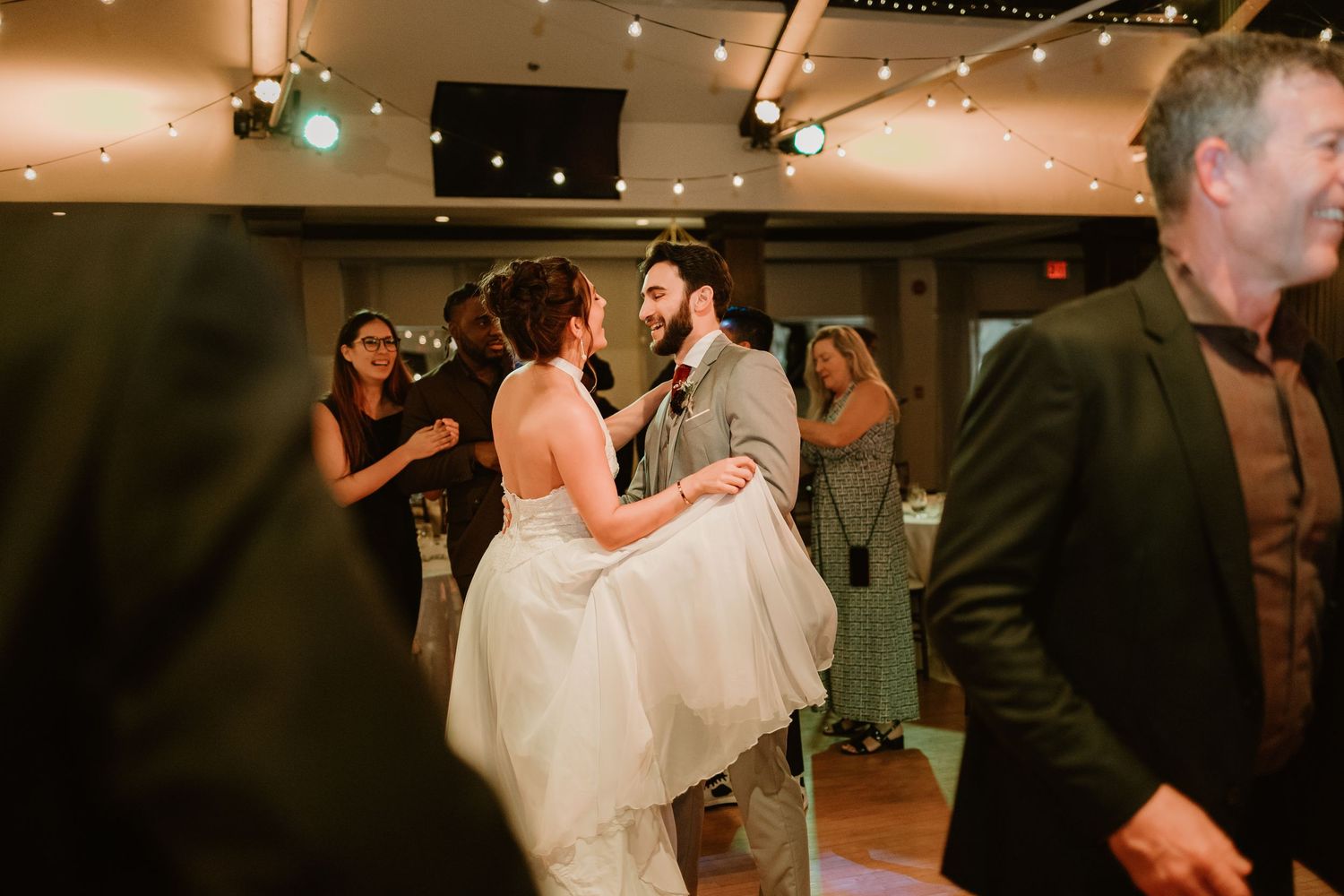 Guests enjoying themselves on the dance floor at an evening wedding reception.