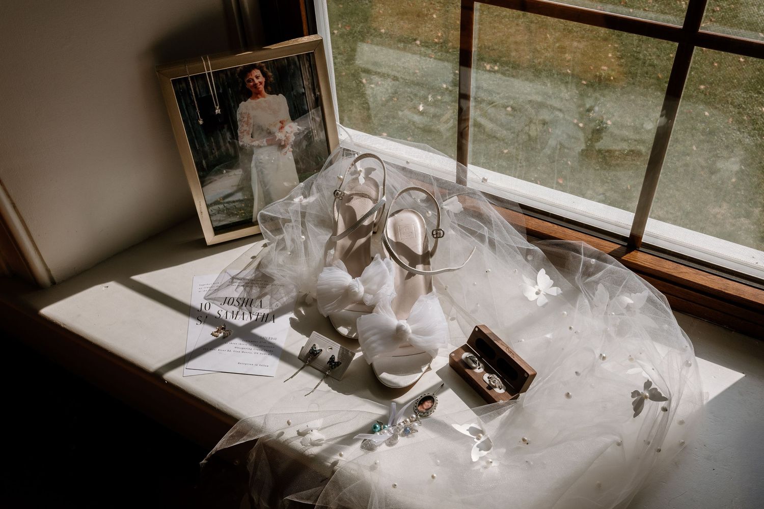 Elegant wedding items displayed near a window with natural lighting.