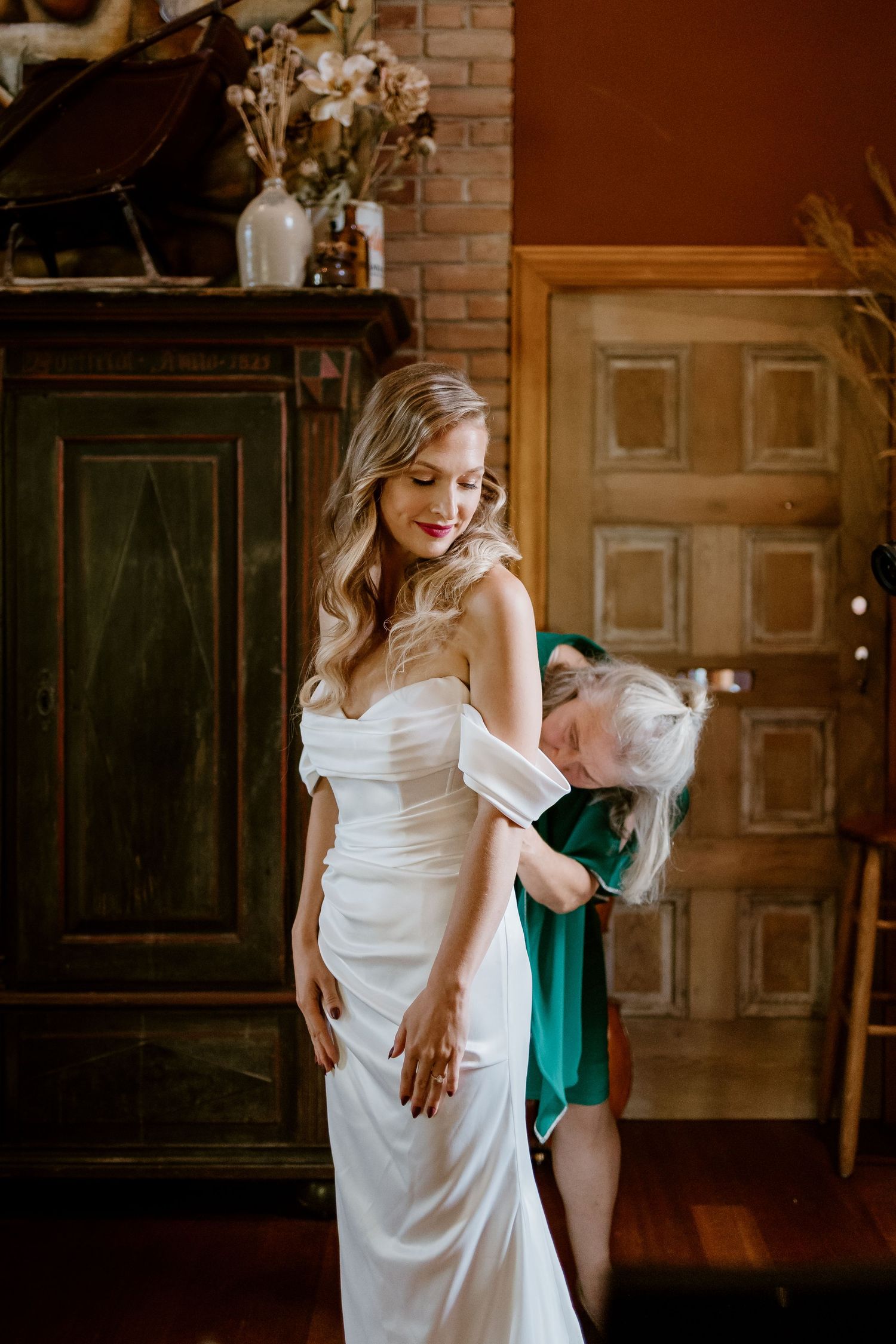 Romantic bridal session in a rustic library with brick walls.