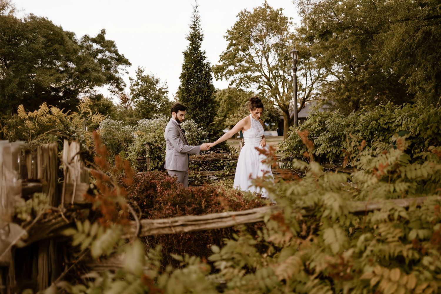 Natural wooded setting with trees and greenery creates a romantic backdrop for outdoor photography.