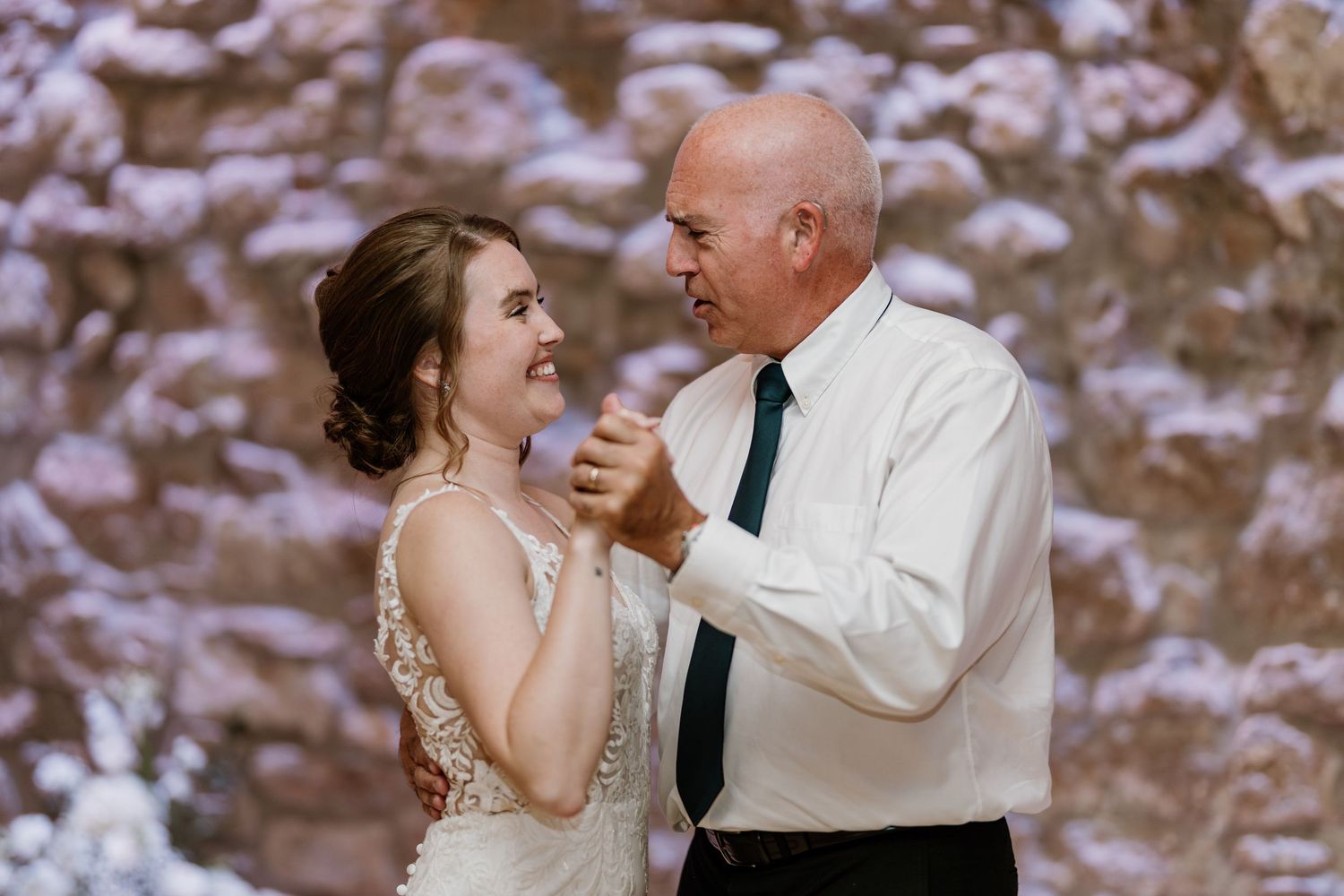 Candid moments of dancing and celebration at elegant wedding reception.