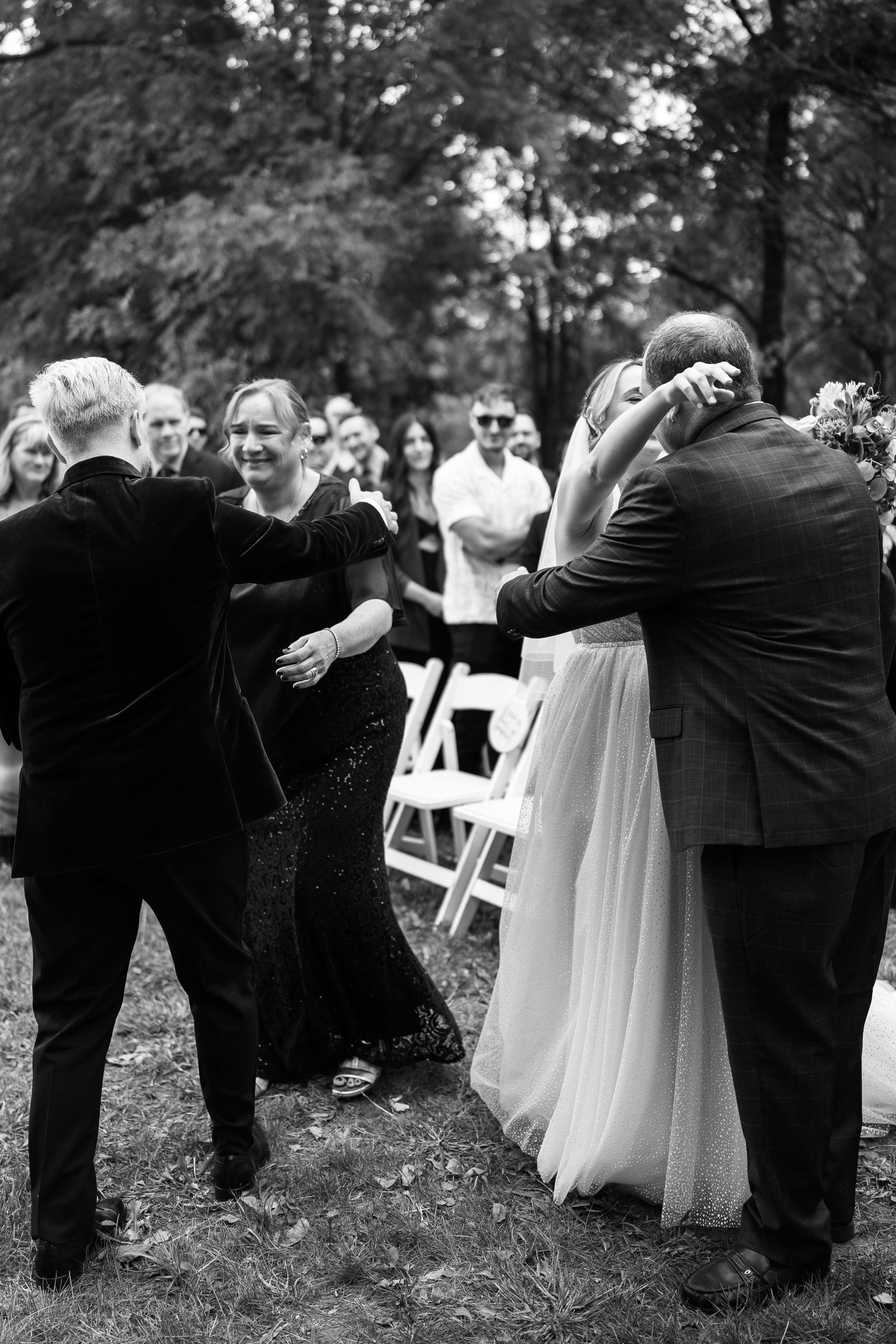 Candid moments between couple during outdoor wedding ceremony.