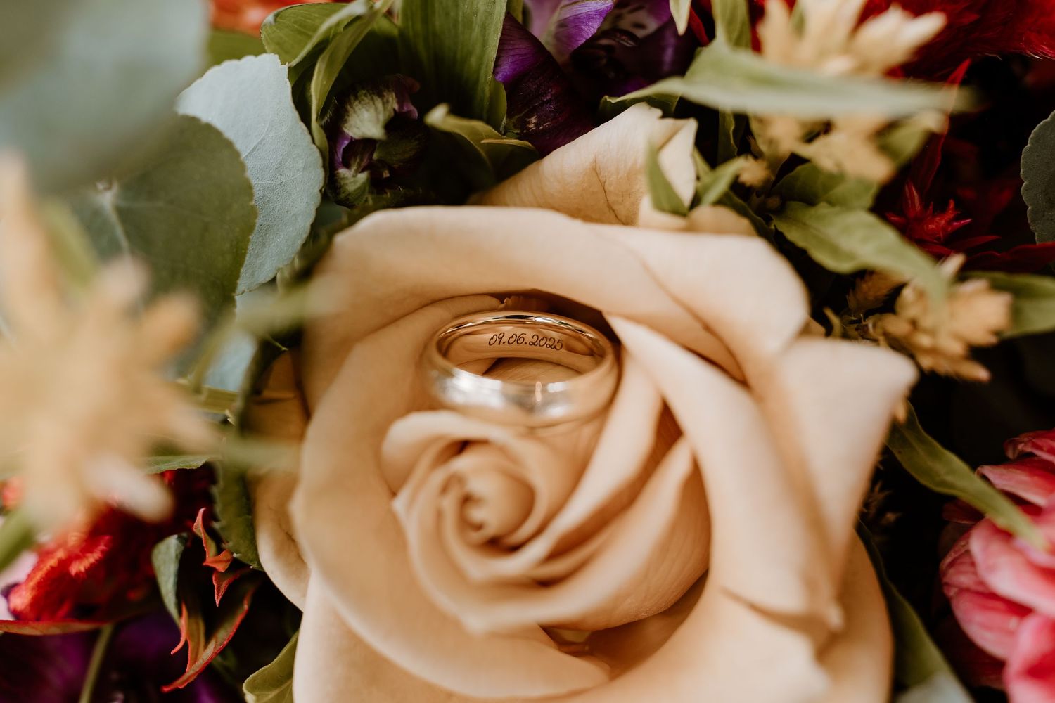 Close-up of a peach-colored rose in a wedding bouquet.