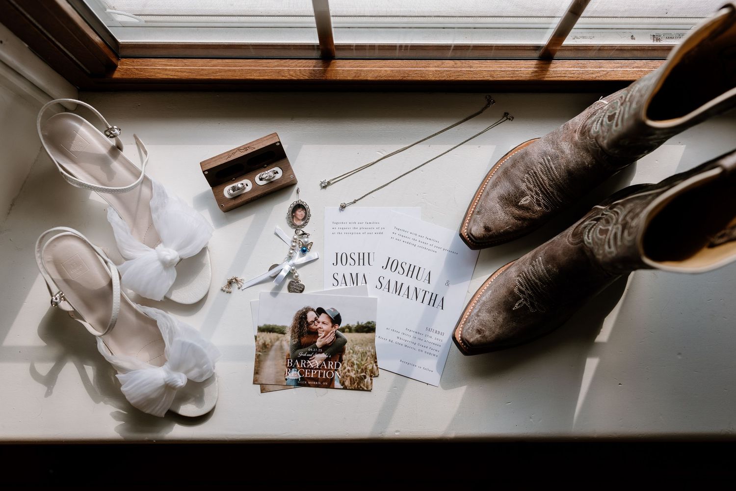 Bridal accessories and decorative elements arranged on a white surface near a window.