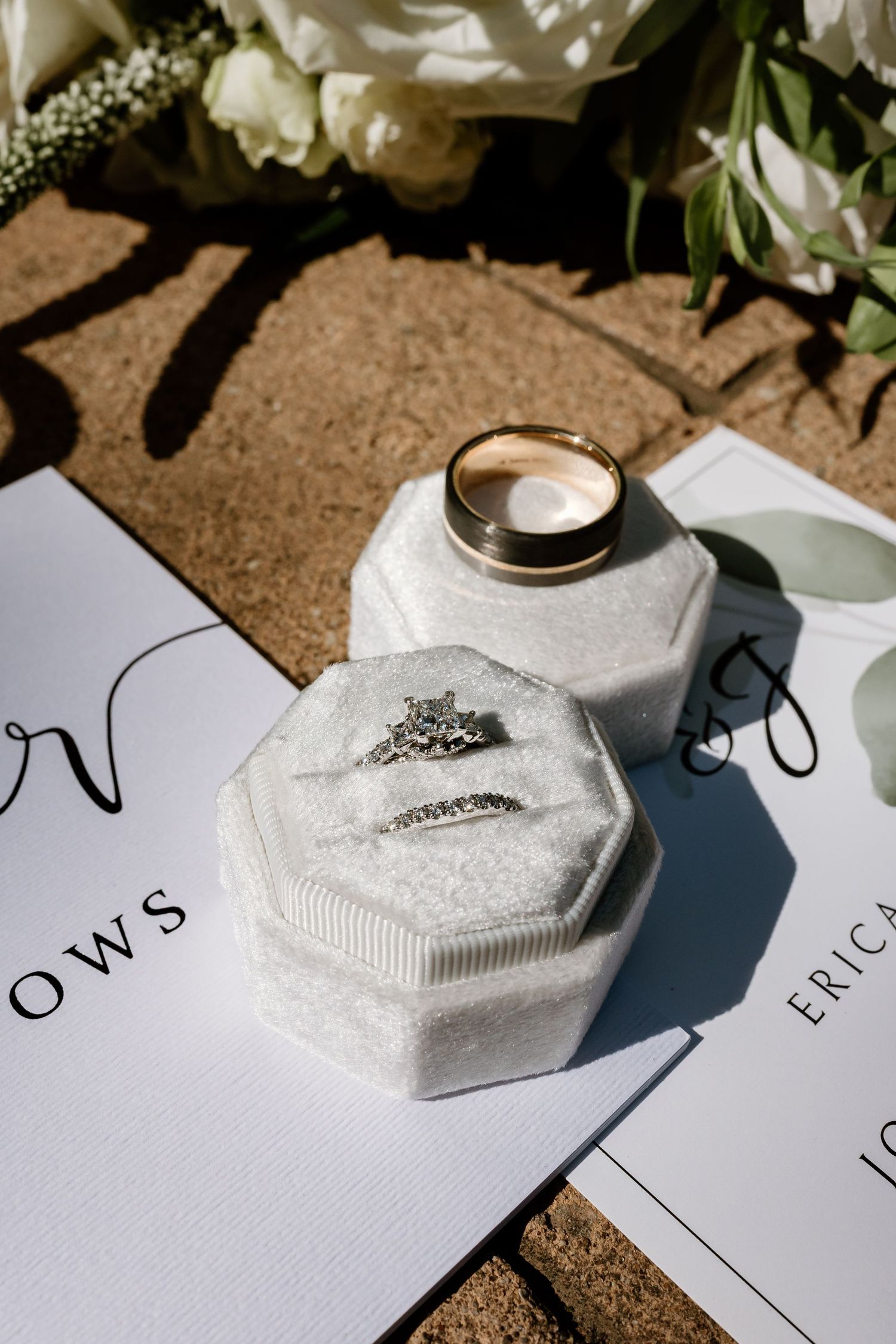 Wedding stationery and decorative elements arranged with elegant white florals.