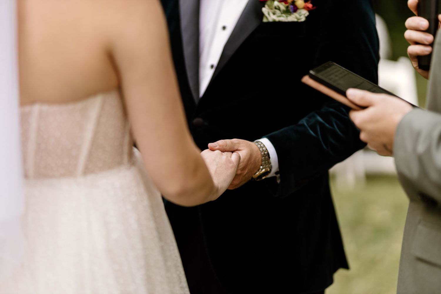 Intimate wedding ceremony moments shared between couple outdoors.