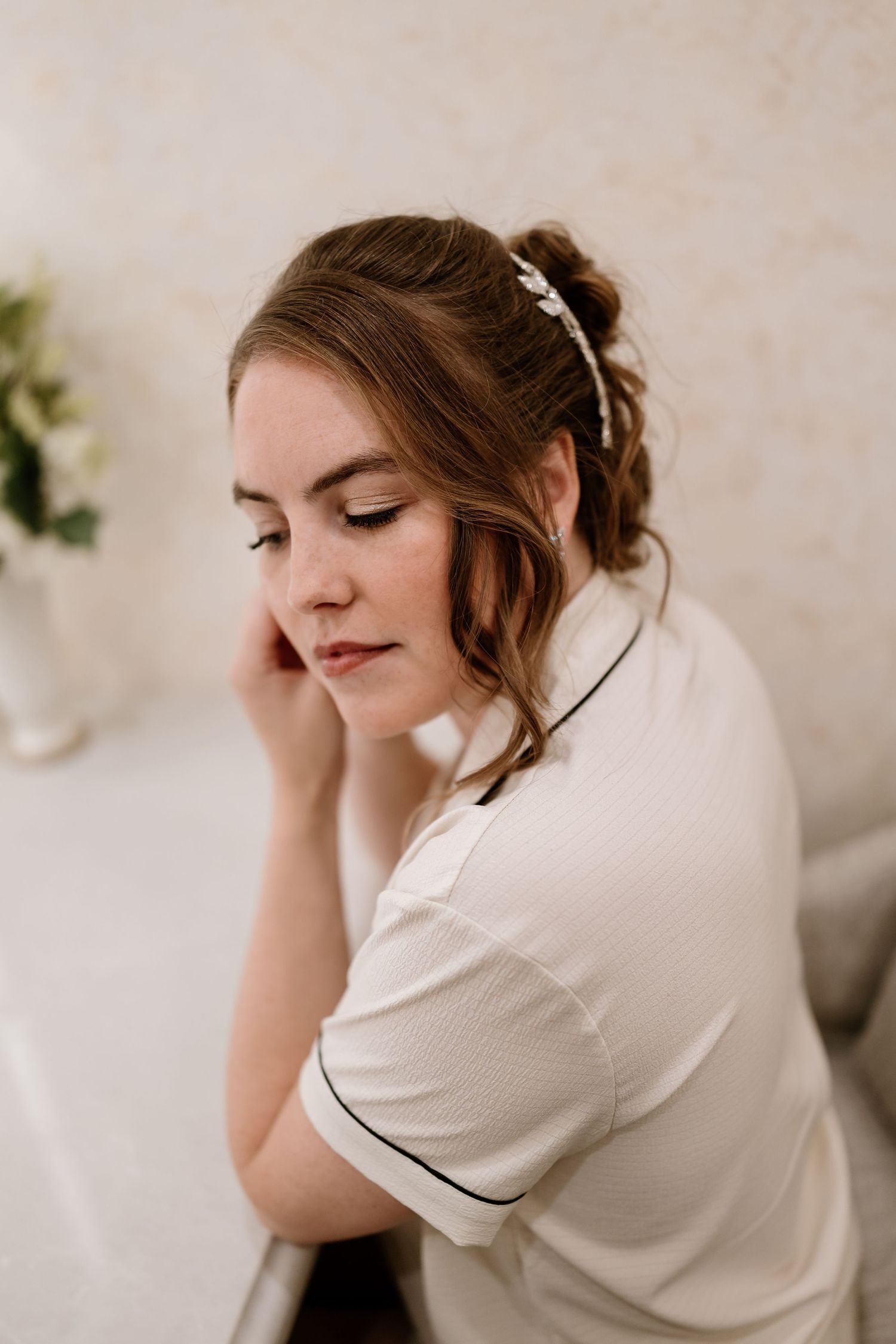 Candid moments of wedding morning preparations in soft lighting.