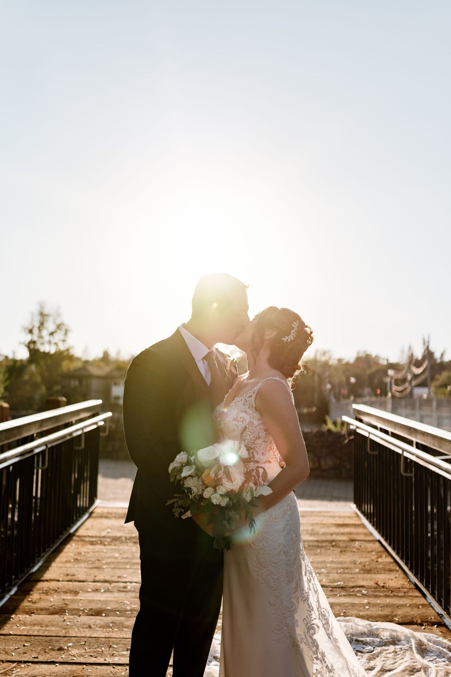 Sunlit wedding portraits on outdoor steps create romantic silhouettes.