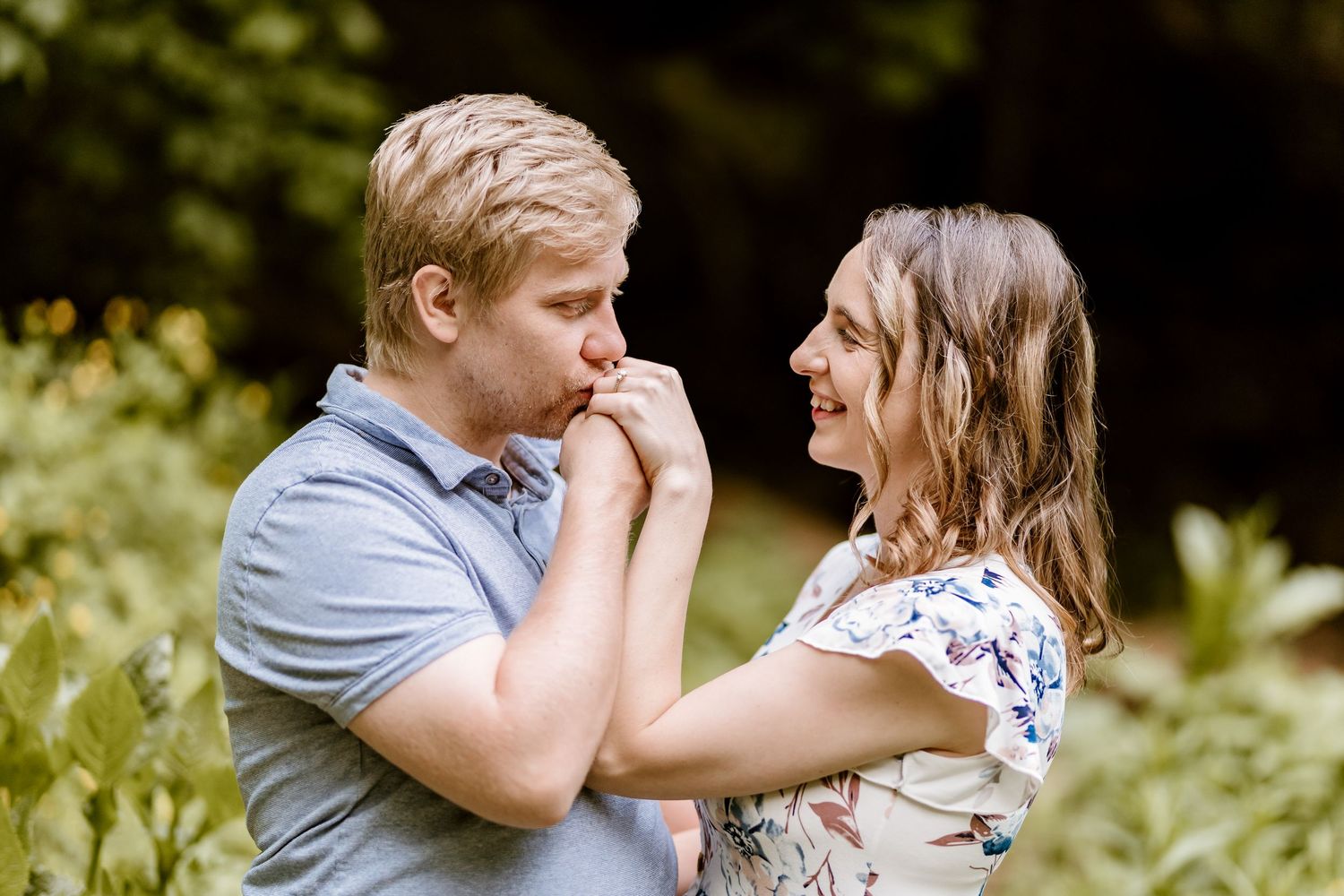 An intimate moment shared between a couple during an outdoor photoshoot.