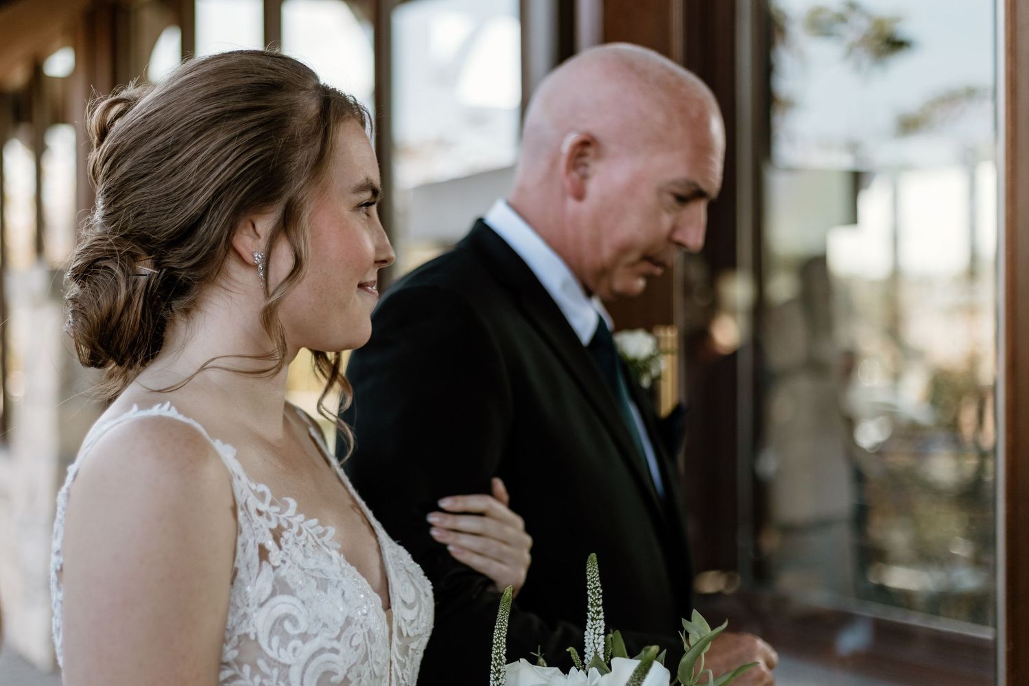 An emotional wedding moment captured by large windows.