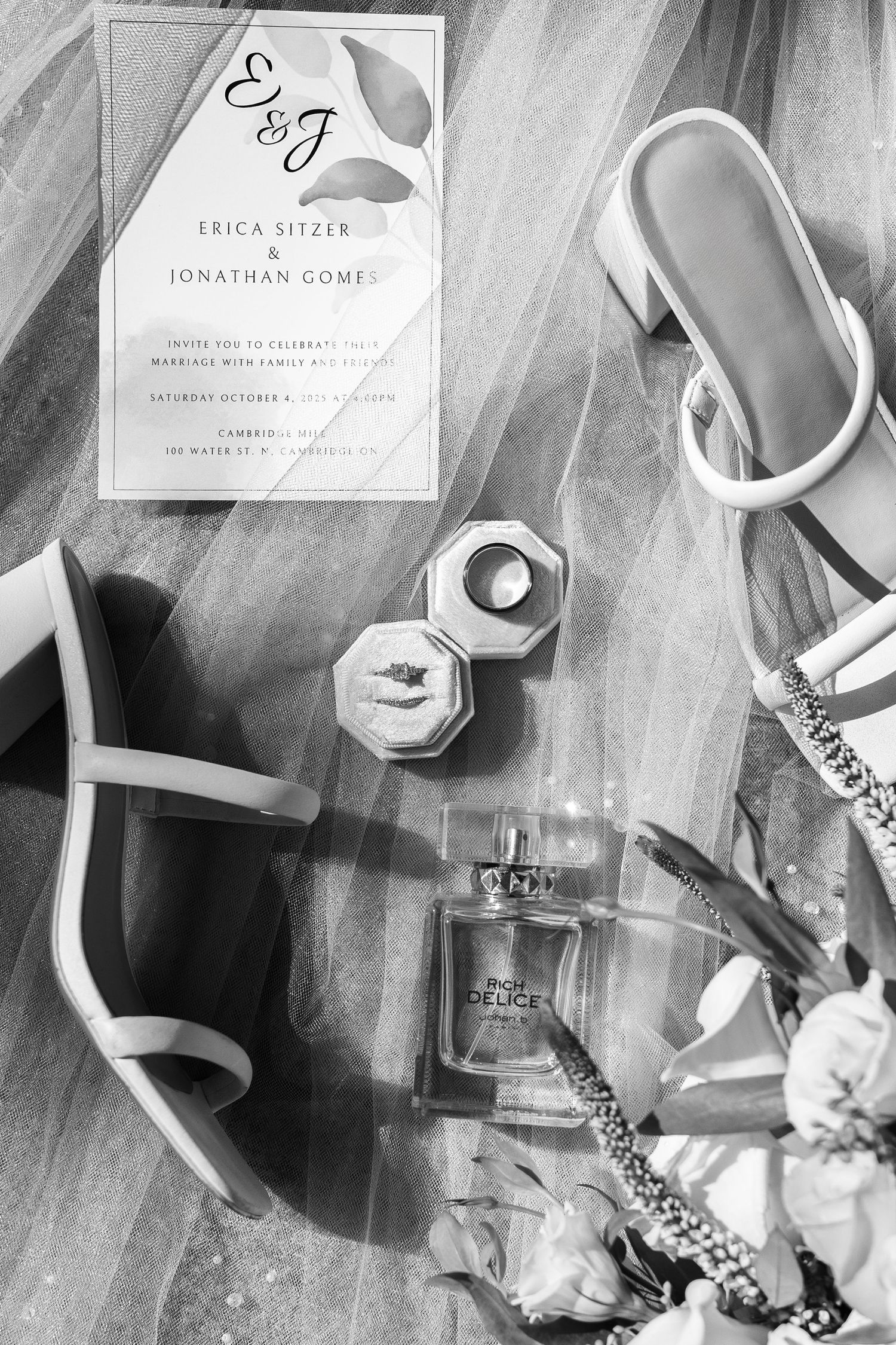 Wedding details including invitation cards, shoes and accessories arranged artistically.