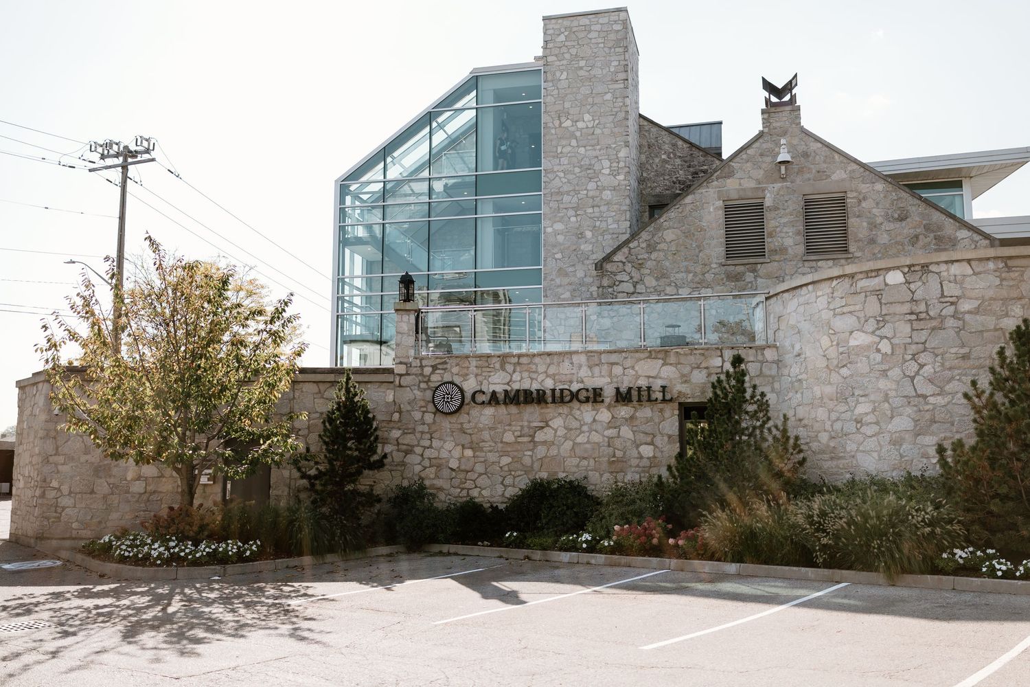 Exterior view of Cambridge Mill stone building with modern glass elements.