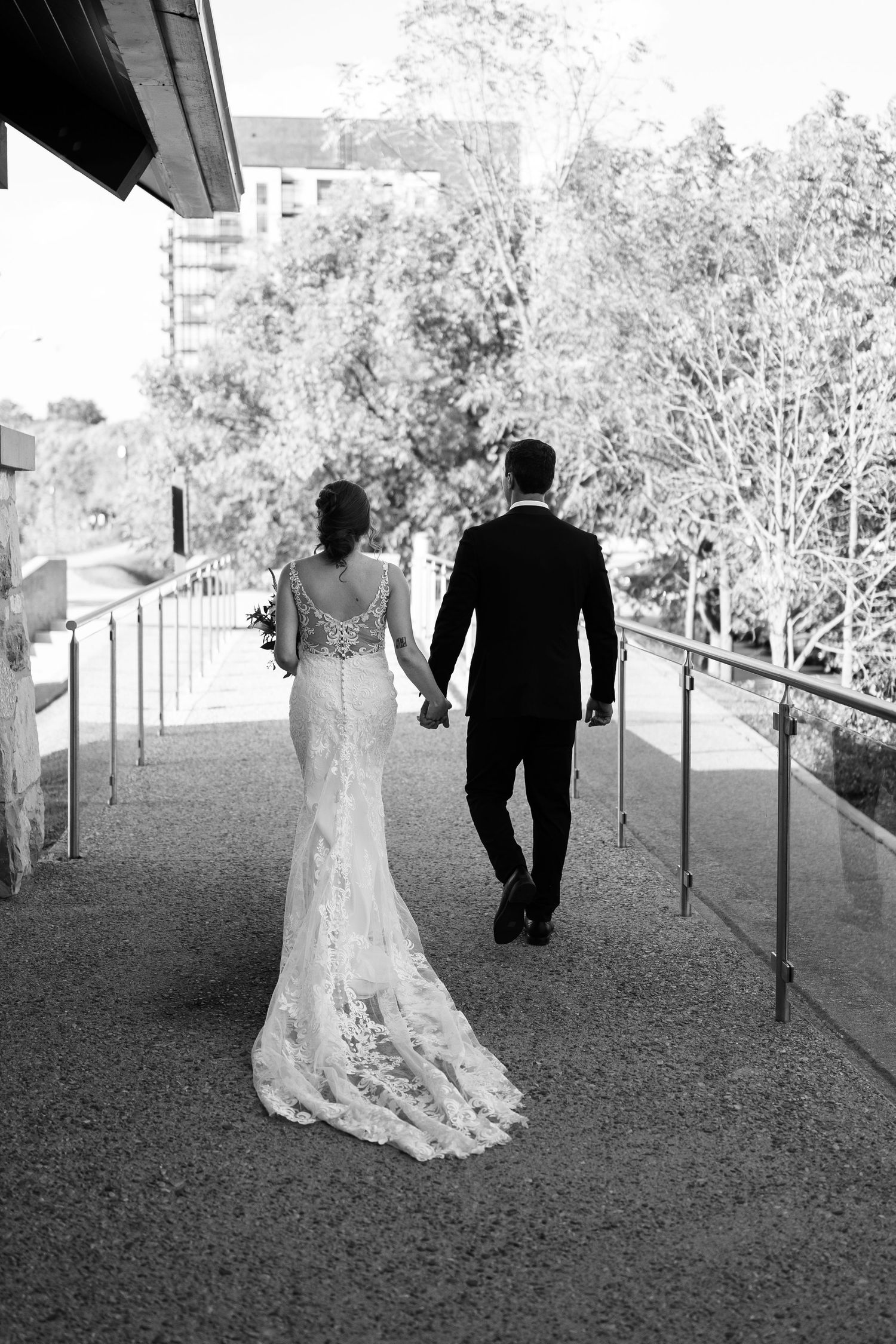 Black and white photos of a couple walking outdoors after their wedding ceremony.