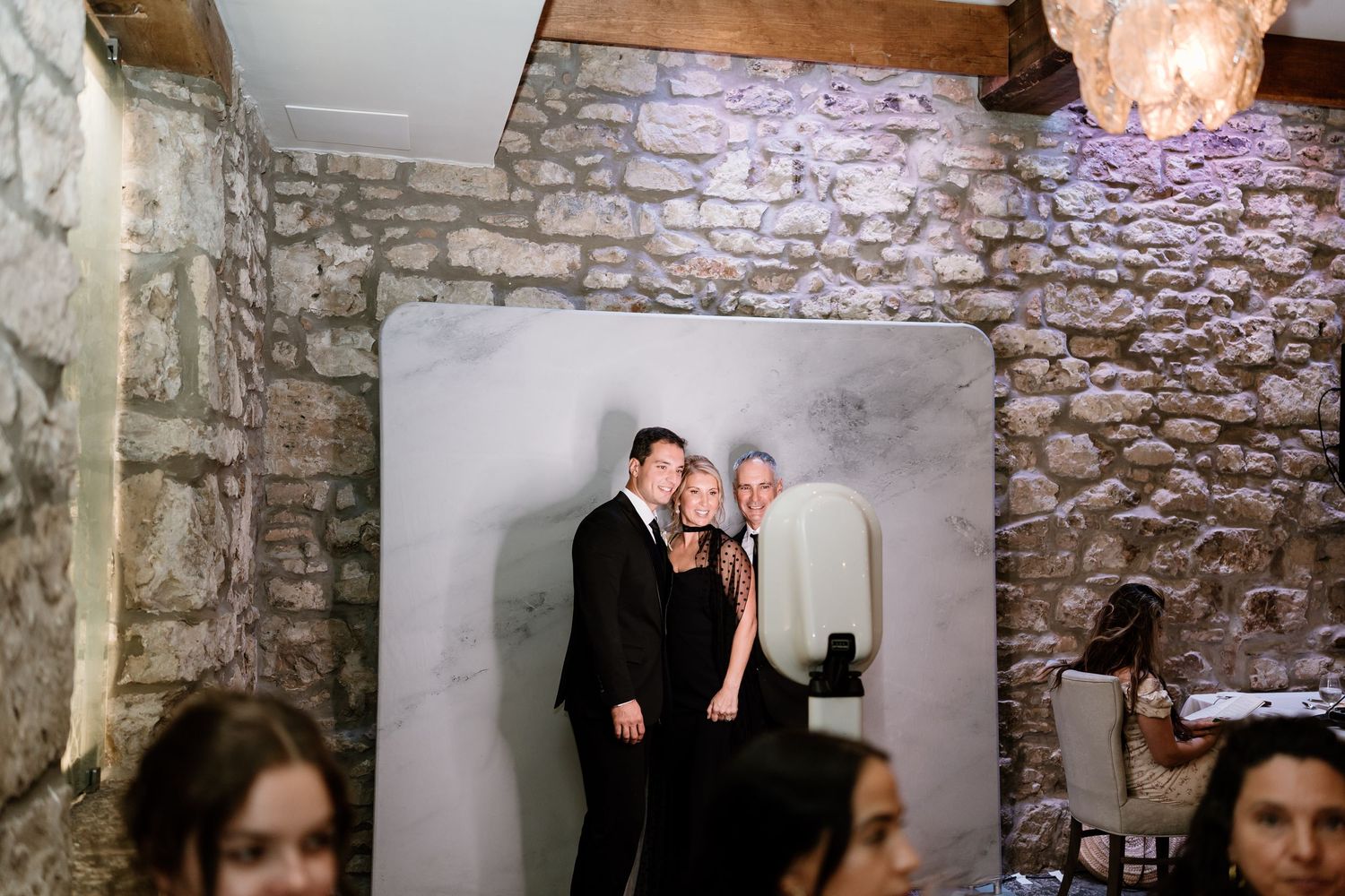 Wedding celebration in rustic venue with exposed stone walls and ambient lighting.