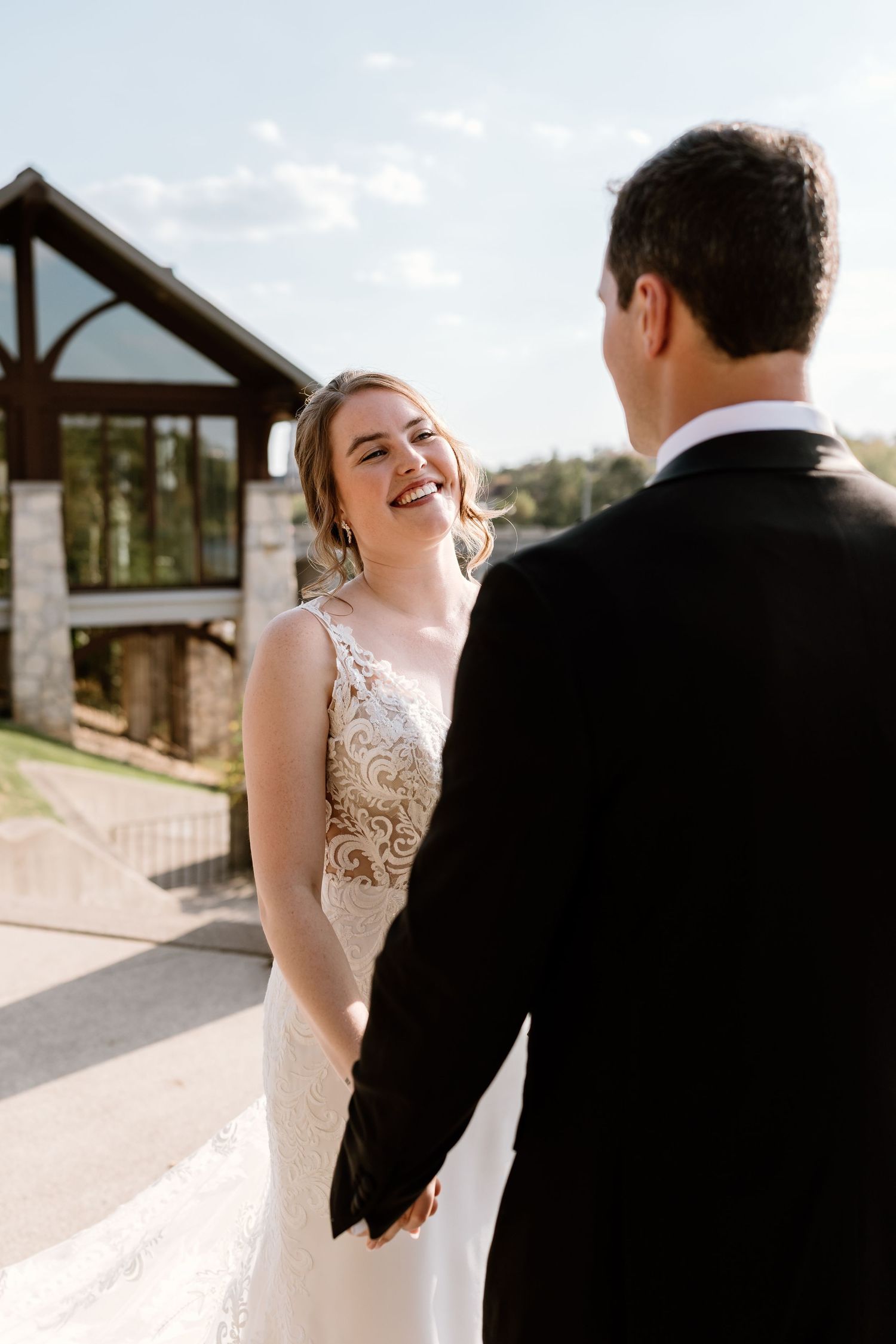Joyful wedding moments shared between the couple on a sunny outdoor patio.