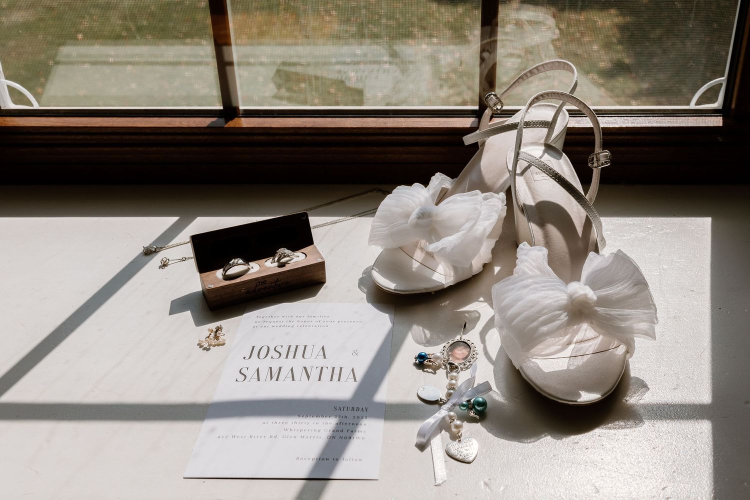 Wedding accessories and personal items artfully displayed on a sunlit window ledge.
