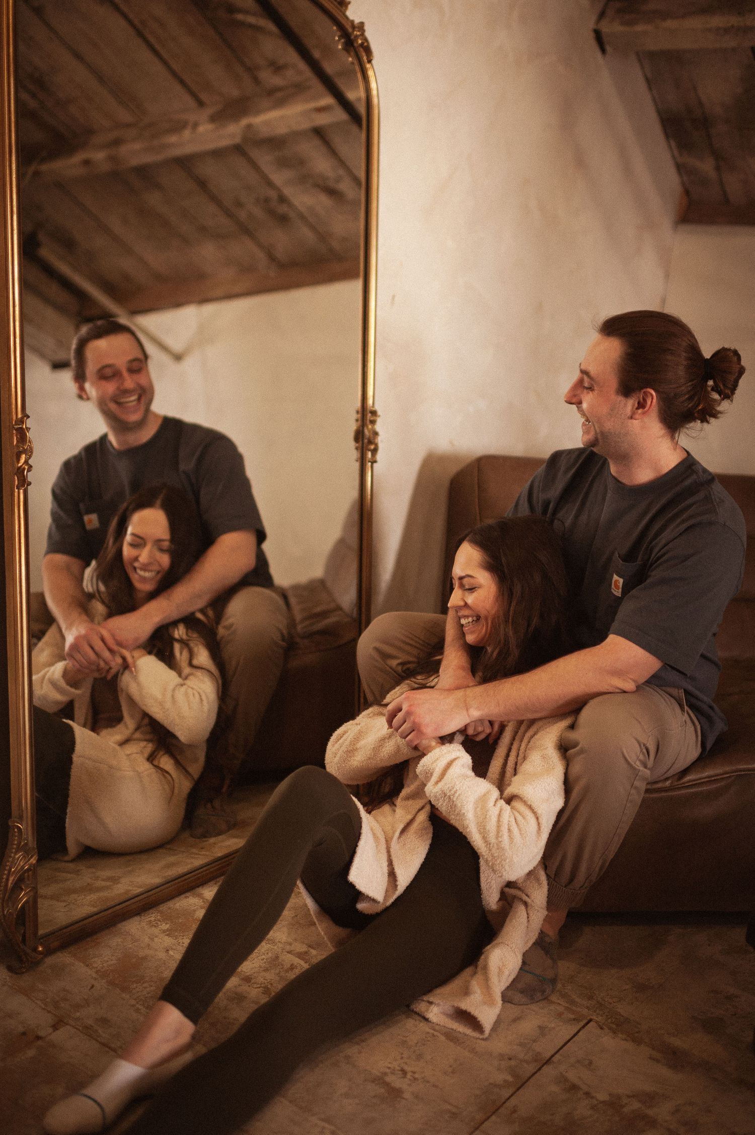 A cozy indoor photoshoot with warm lighting and rustic wooden elements.