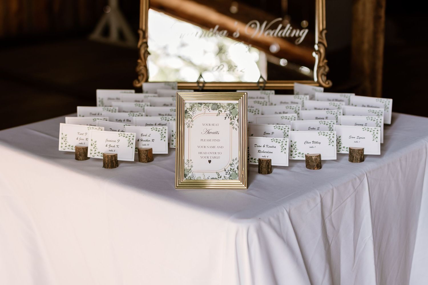 Wedding place cards elegantly displayed on a white tablecloth.