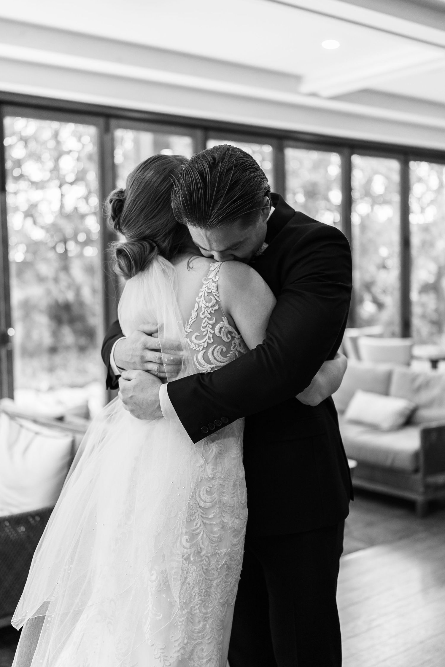 An intimate black and white wedding moment captured during a first look.