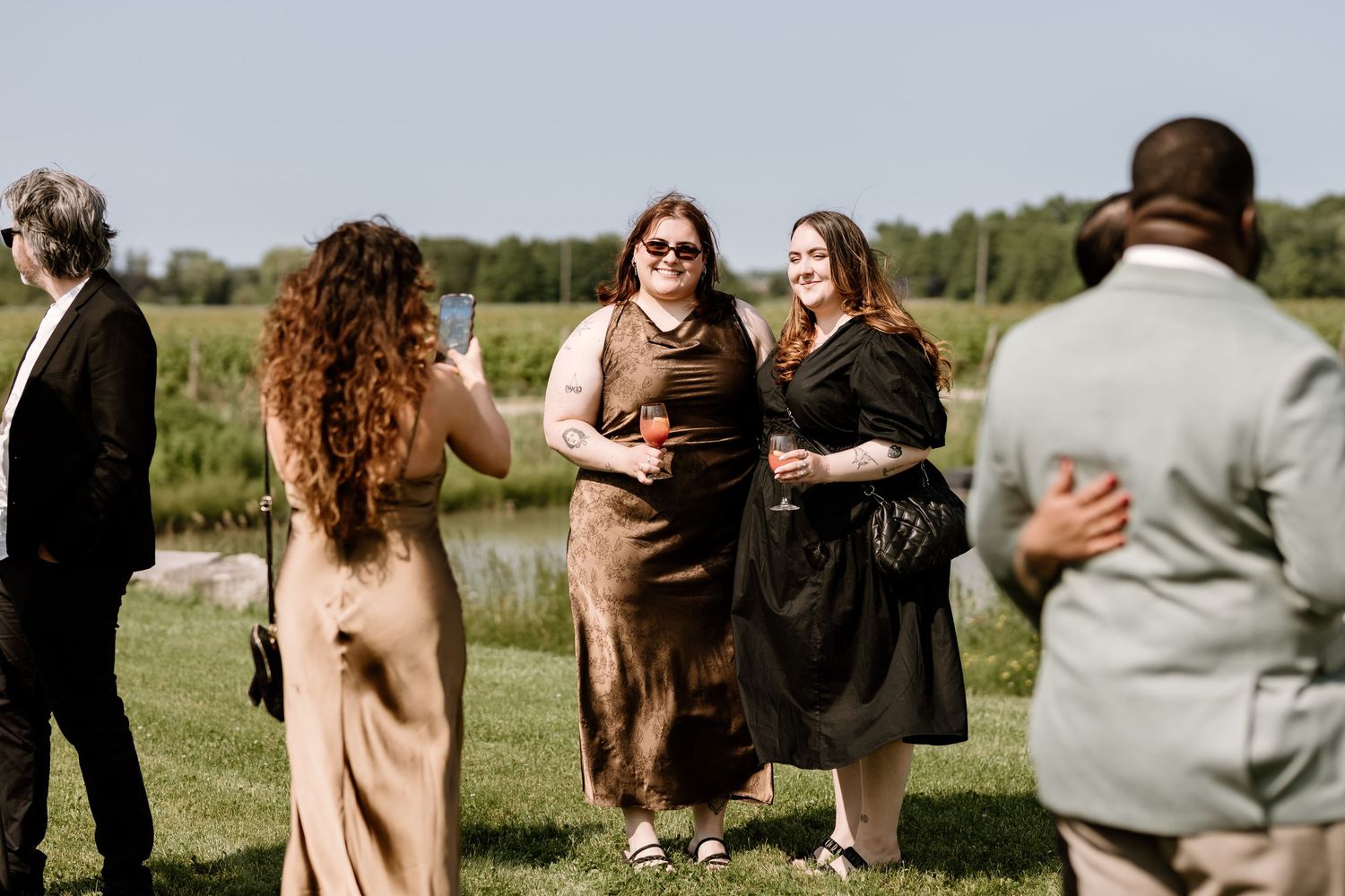 Wedding guests mingling and socializing during outdoor reception.