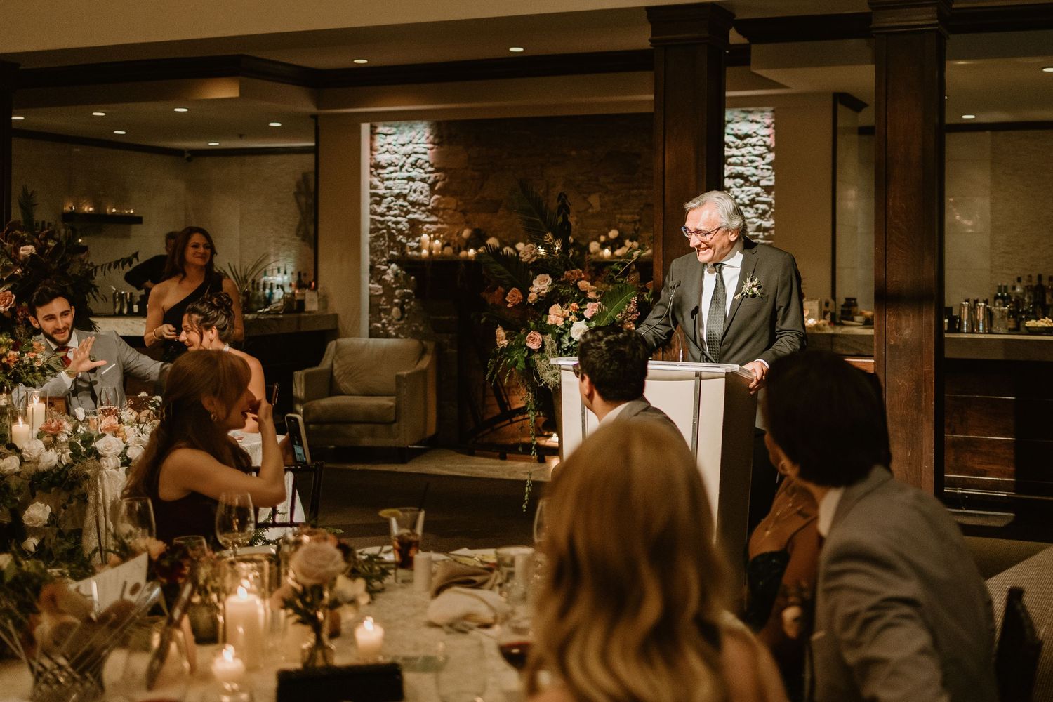 Elegant wedding reception venue with string lights and guests enjoying the celebration.