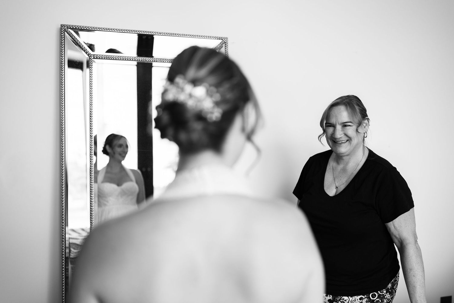 Black and white photos show wedding preparation moments in a bridal suite.