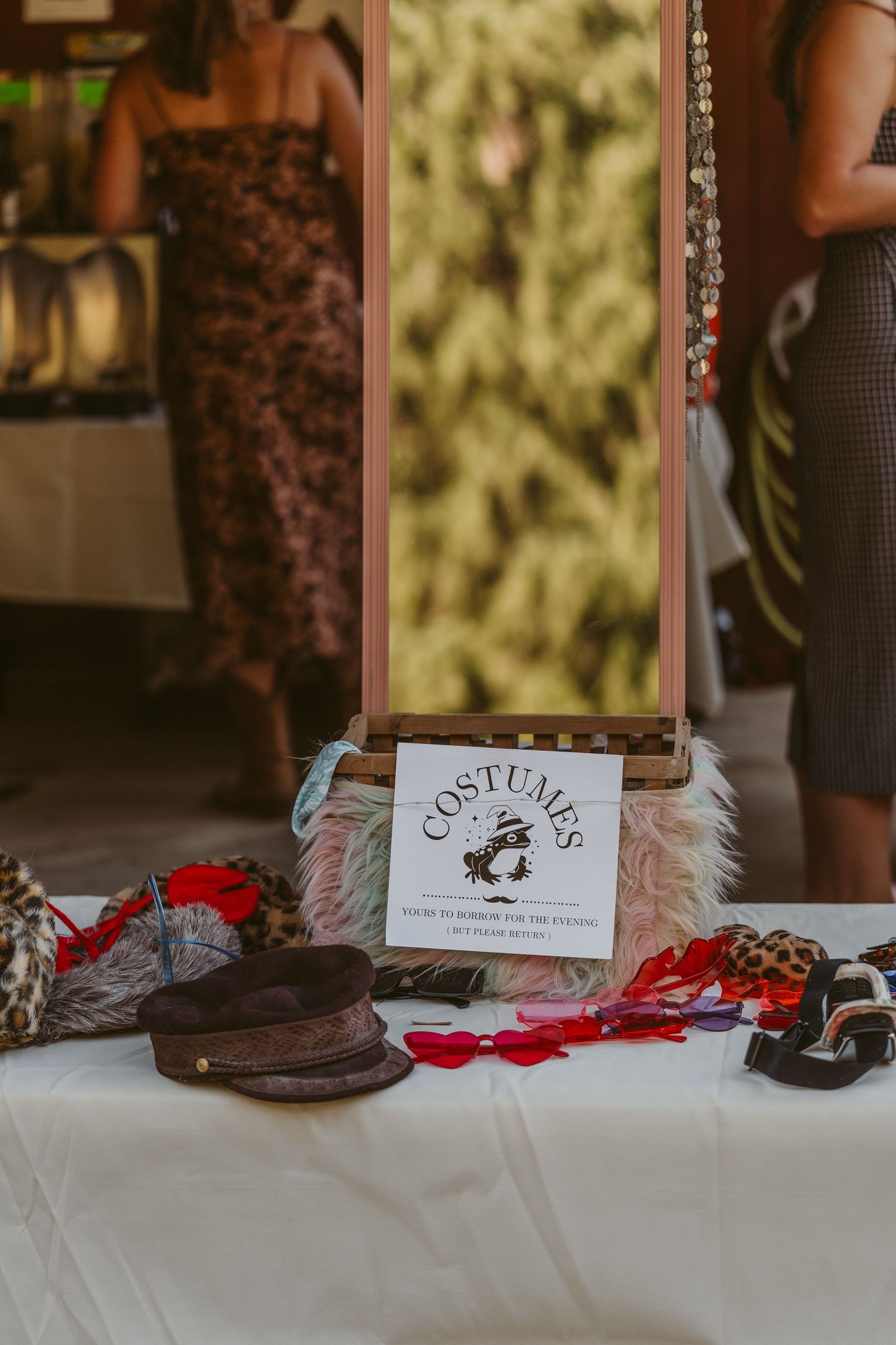 Vintage leather shoes and accessories displayed on white tablecloth for a wedding detail shot.