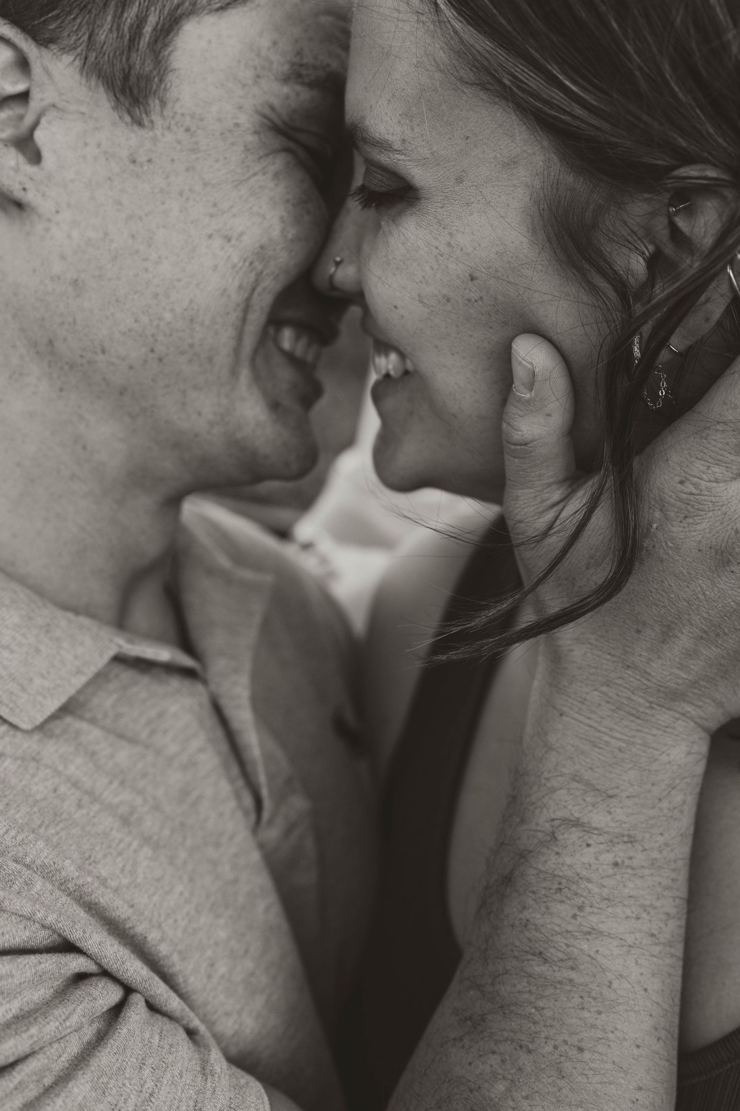 A romantic black and white close-up photo of a couple sharing an intimate moment together.
