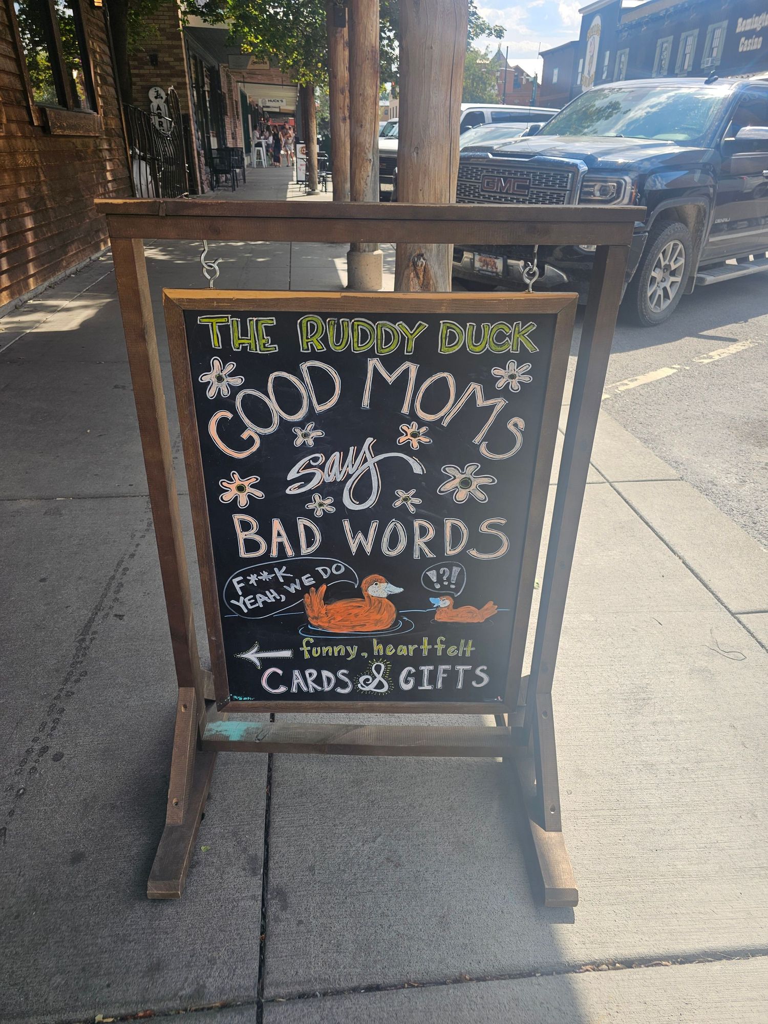 A series of chalkboard sidewalk signs for 'The Ruddy Duck' shop in Whitefish, Montana displaying a witty joke.