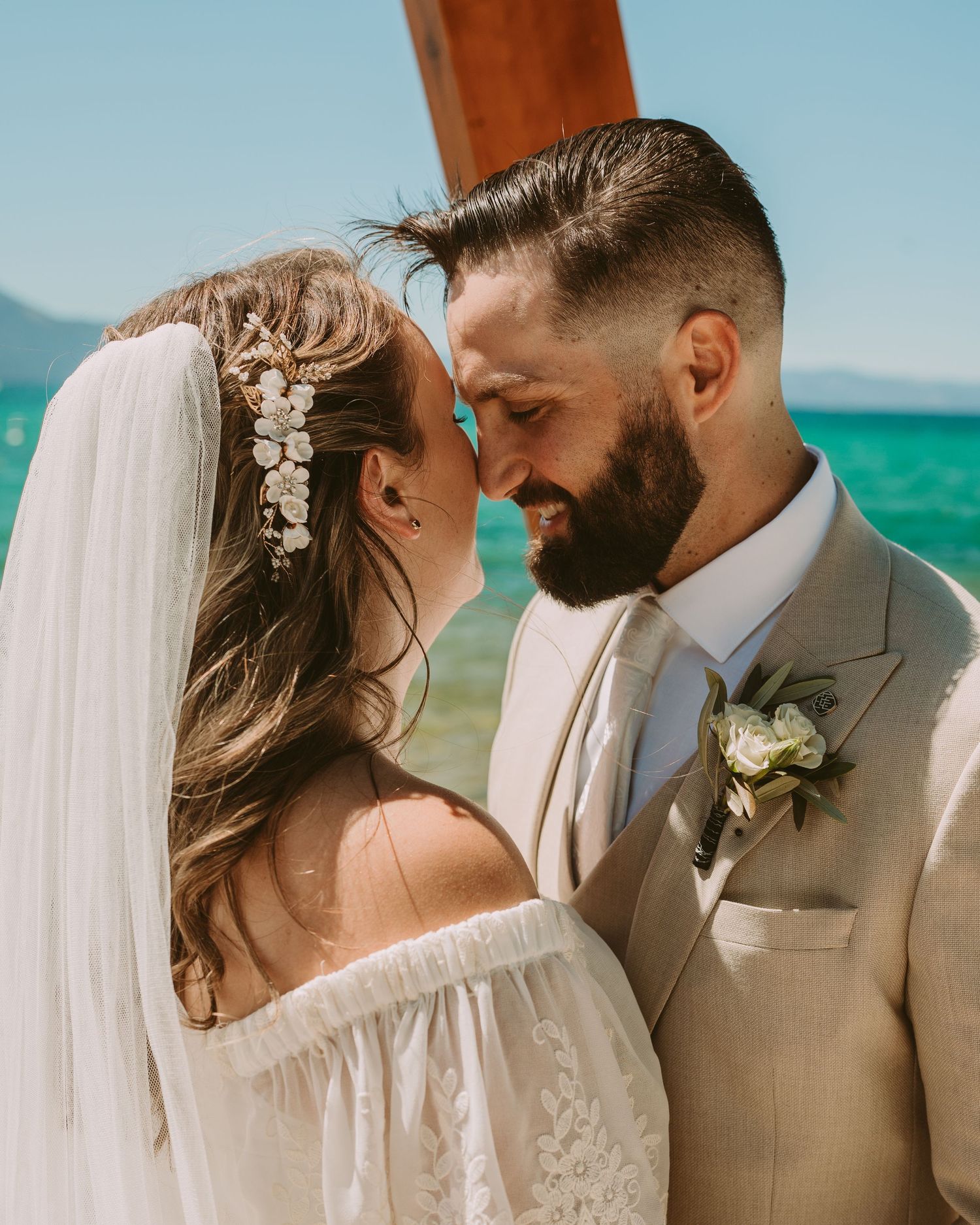A romantic beach wedding couple shares intimate moments in a series of candid photos against turquoise waters.