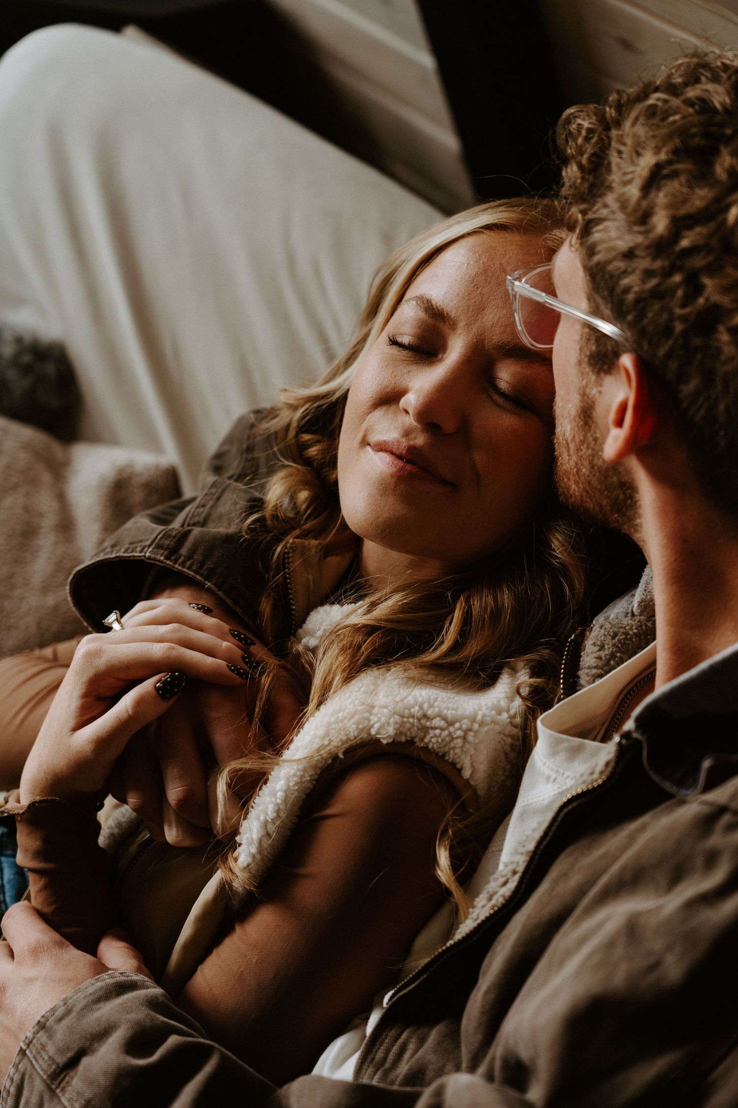 Intimate couple sharing tender moments together in a series of warm, moody photographs.