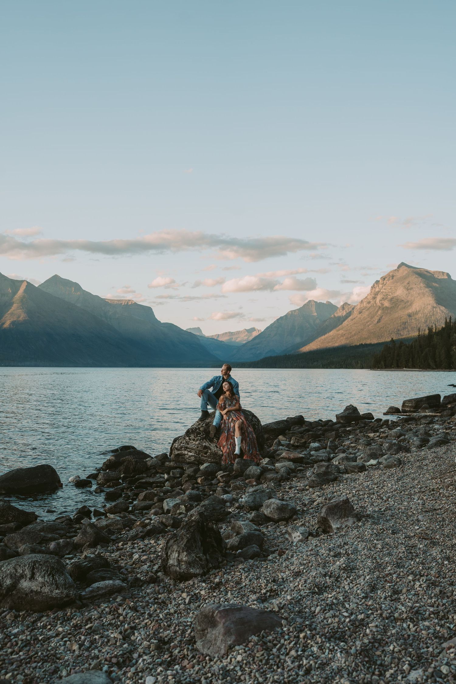 Couple sitting on a rocky shoreline at sunset with mountains and lake views across multiple scenic landscape photographs.