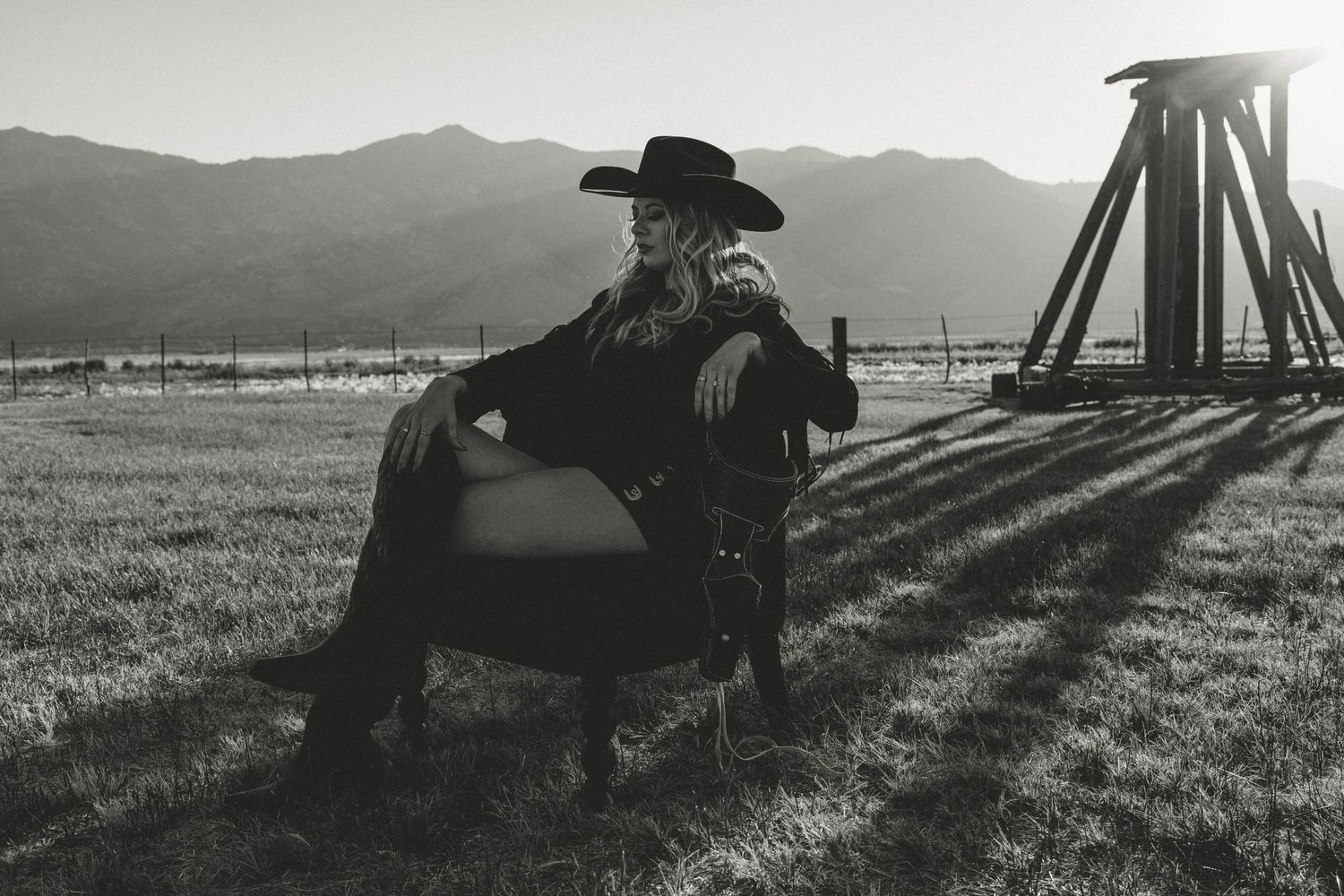 A series of black and white photographs showing silhouettes of people against a mountainous landscape at sunset.