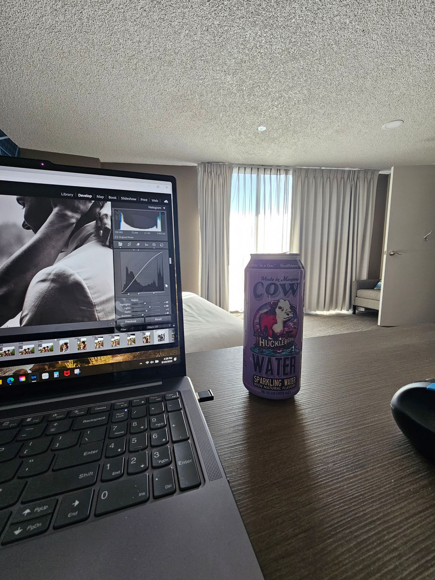 Multiple laptop screens and a purple beverage can shown on a dark wooden desk in various angles and lighting conditions.