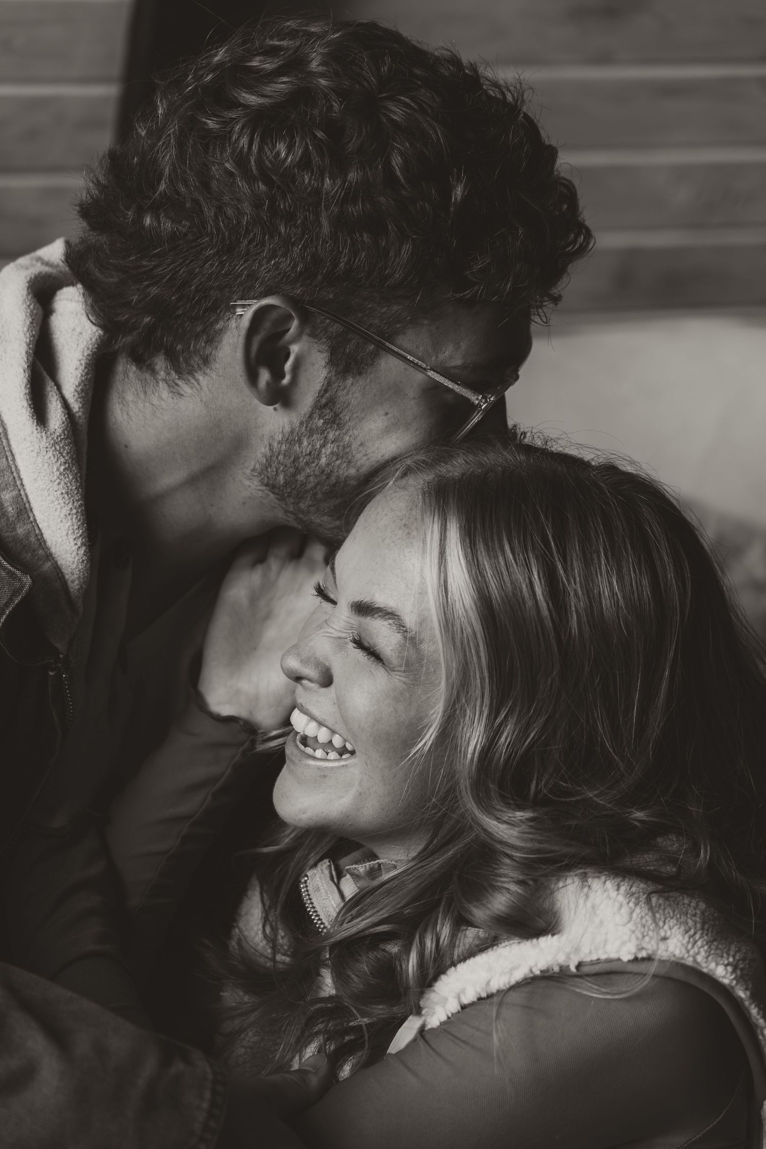 A series of intimate black and white photographs showing a tender romantic moment between a couple in close embrace.
