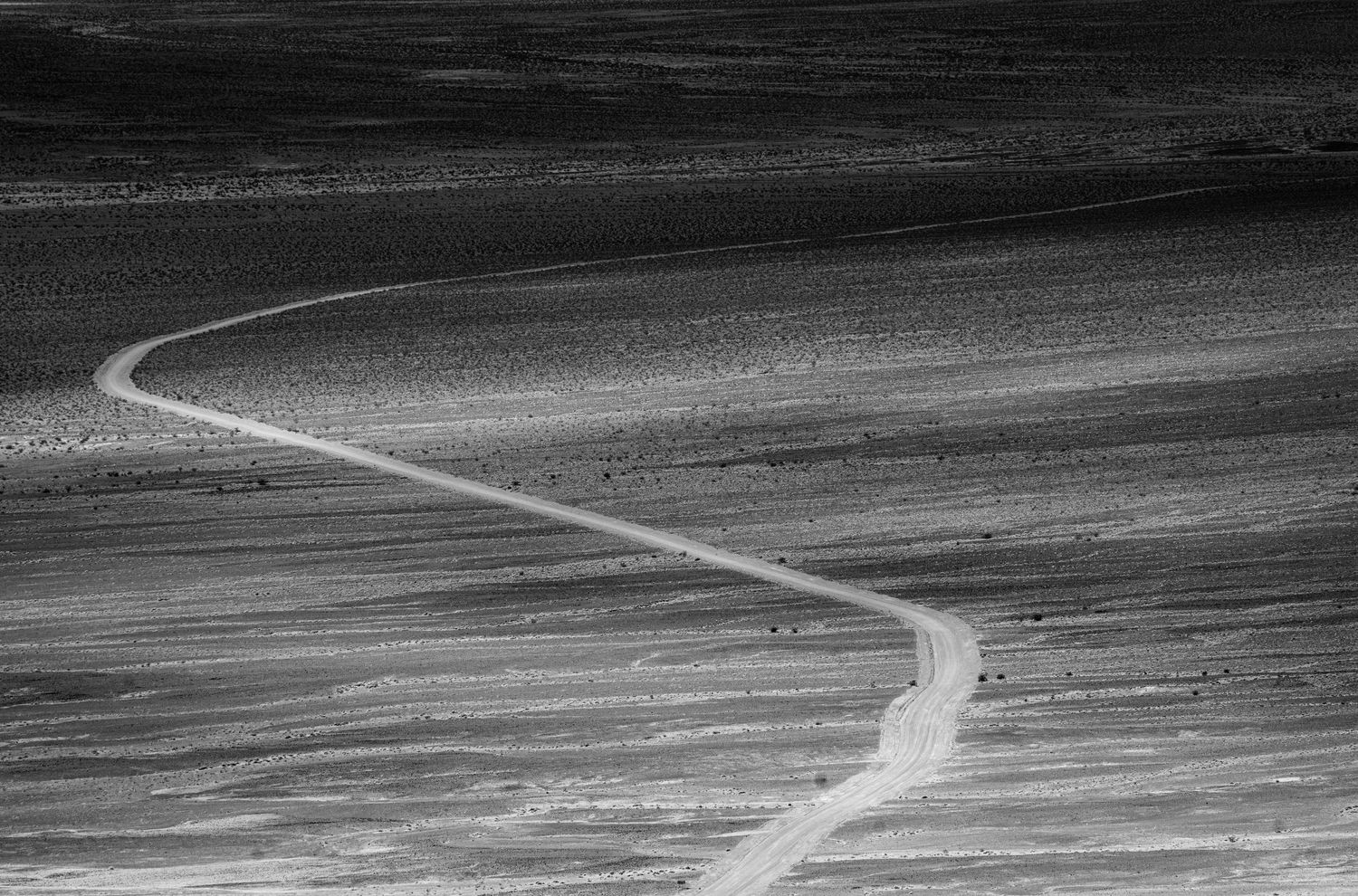 black and white image of a dirt road to the eureka dunes