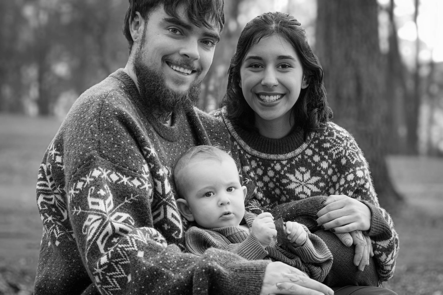 A series of black and white family portraits showing candid moments outdoors.