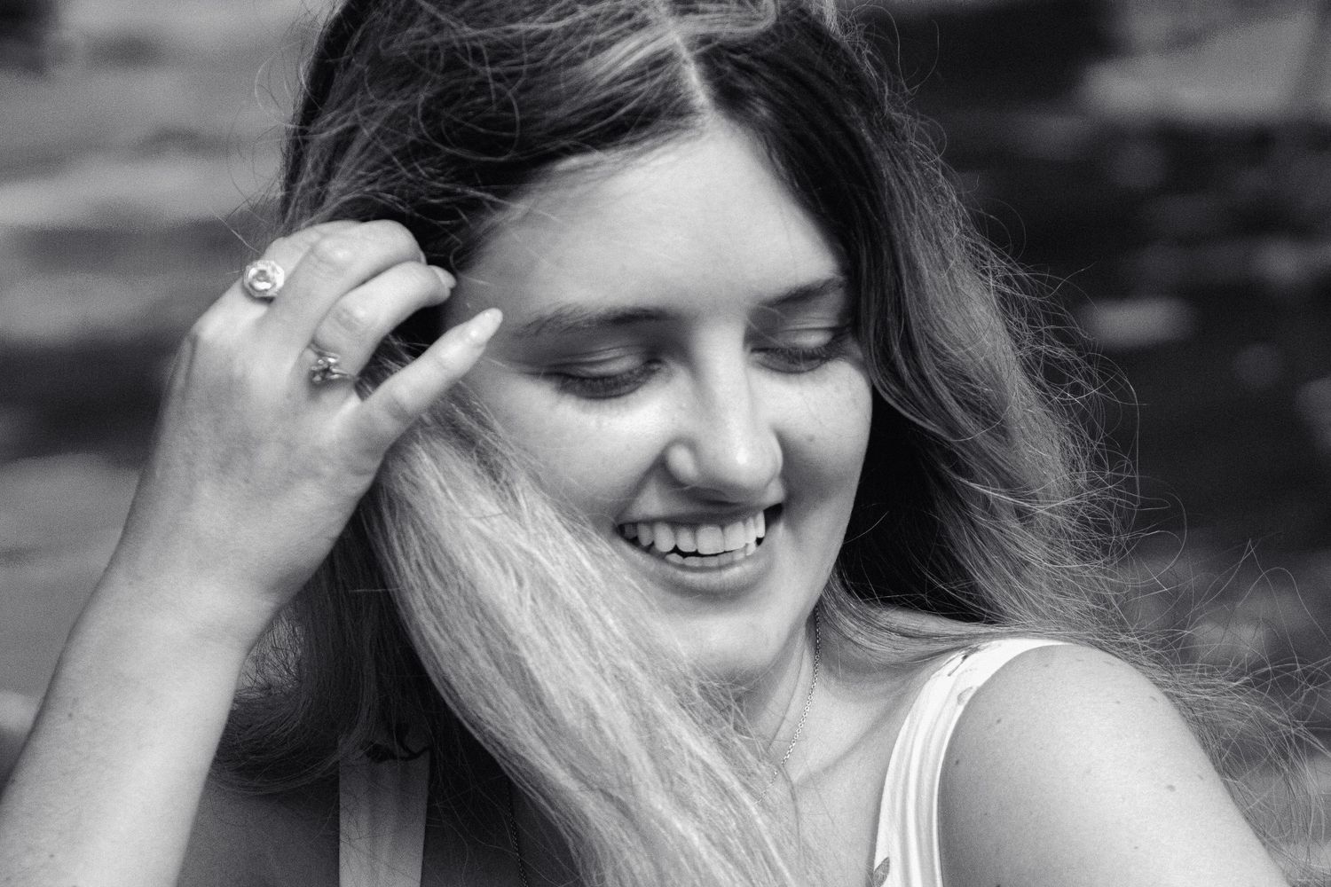 A candid black and white portrait showing joyful expressions and natural emotion.