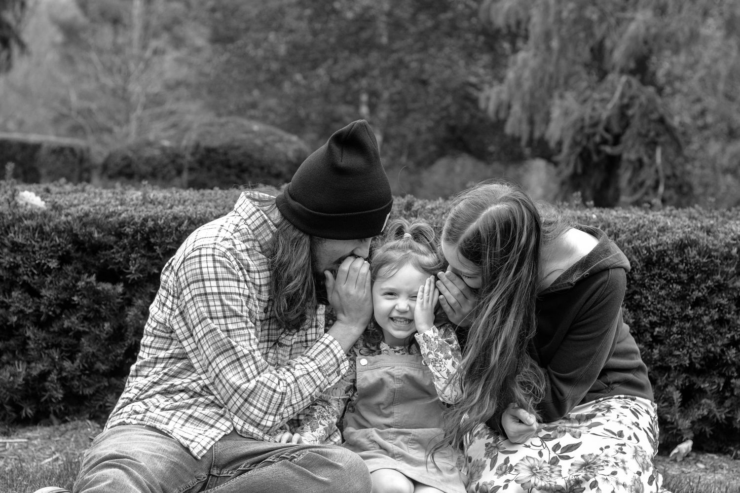 A family enjoys a warm autumn day together outdoors.
