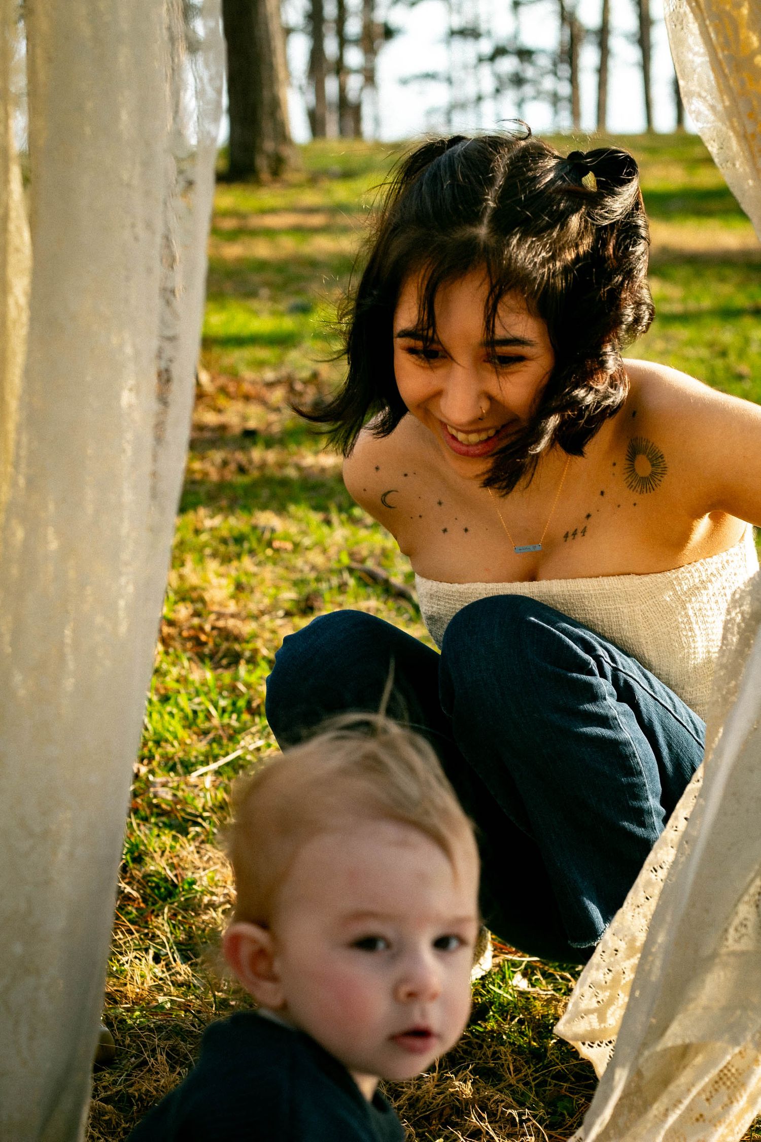 A series of intimate family portraits captured through white curtains in outdoor natural lighting during golden hour.